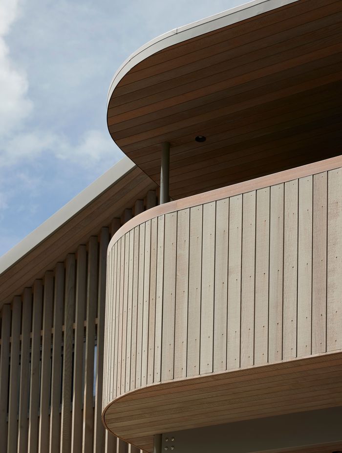 The western elevation’s sheltered upper deck, curved in design to soften its dominant height. | Photographer: Jackie Meiring