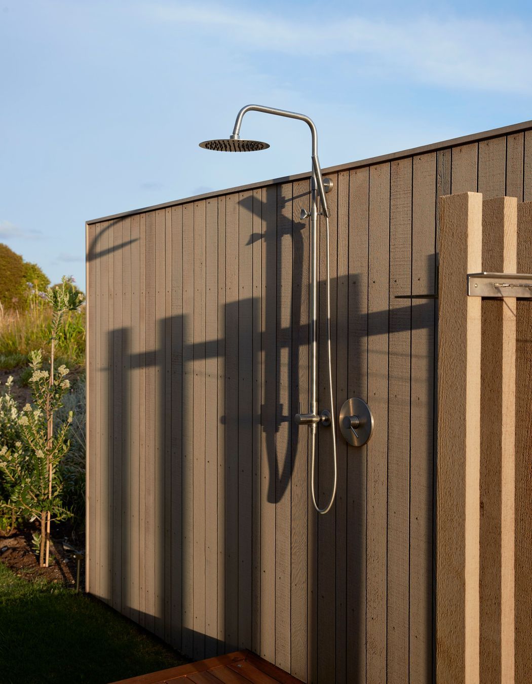 The outdoor shower, sheltered by a cedar-clad fence. | Photographer: Jackie Meiring