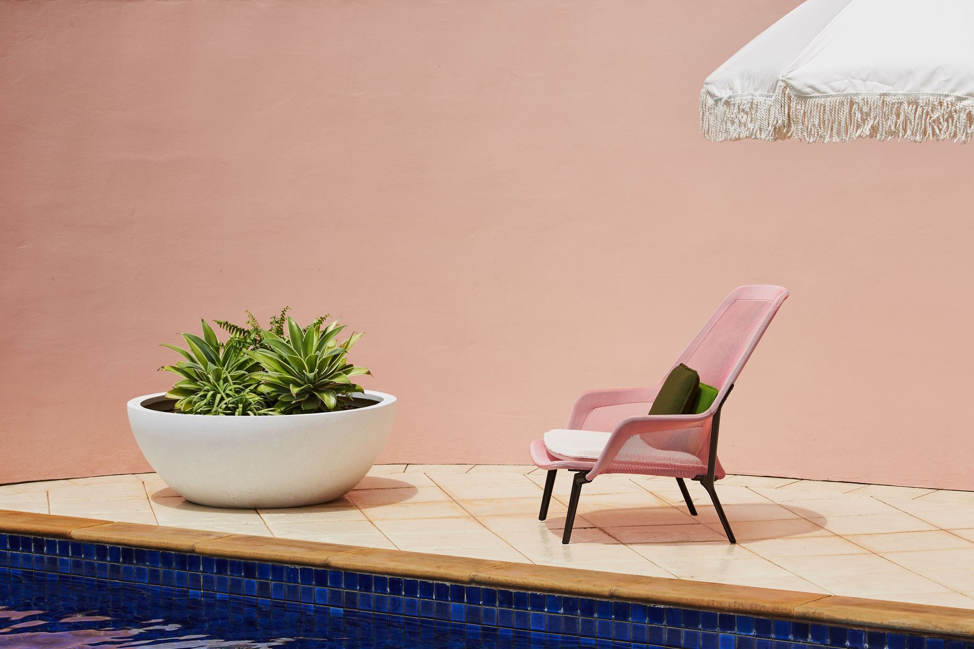 The wall wrapping around the outdoor spaces was painted in a soft dirty pink and gives off a real holiday vibe.