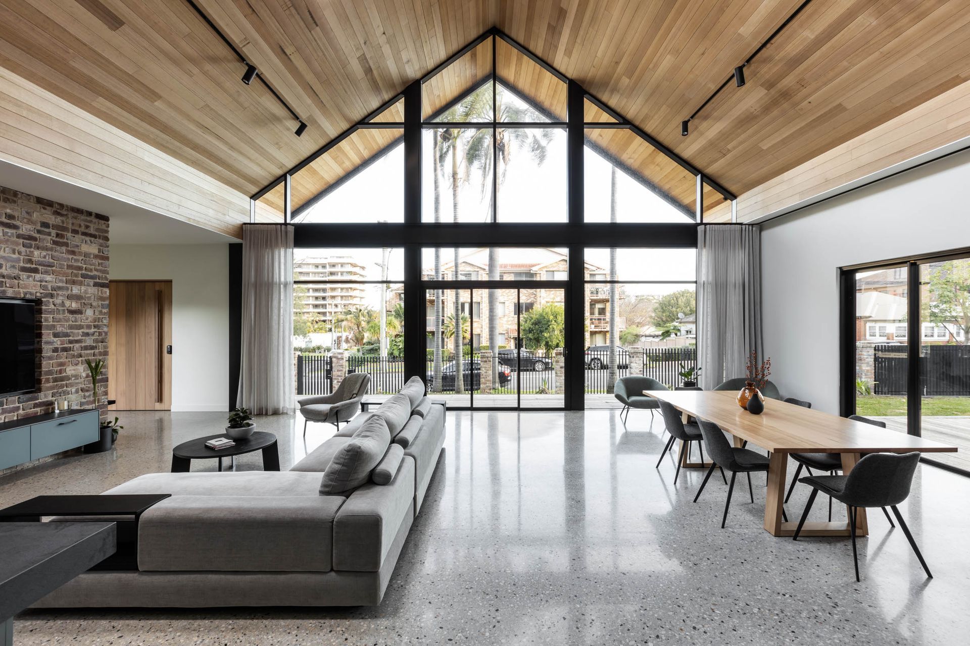 Polished concrete floors balance the warm timber ceiling.