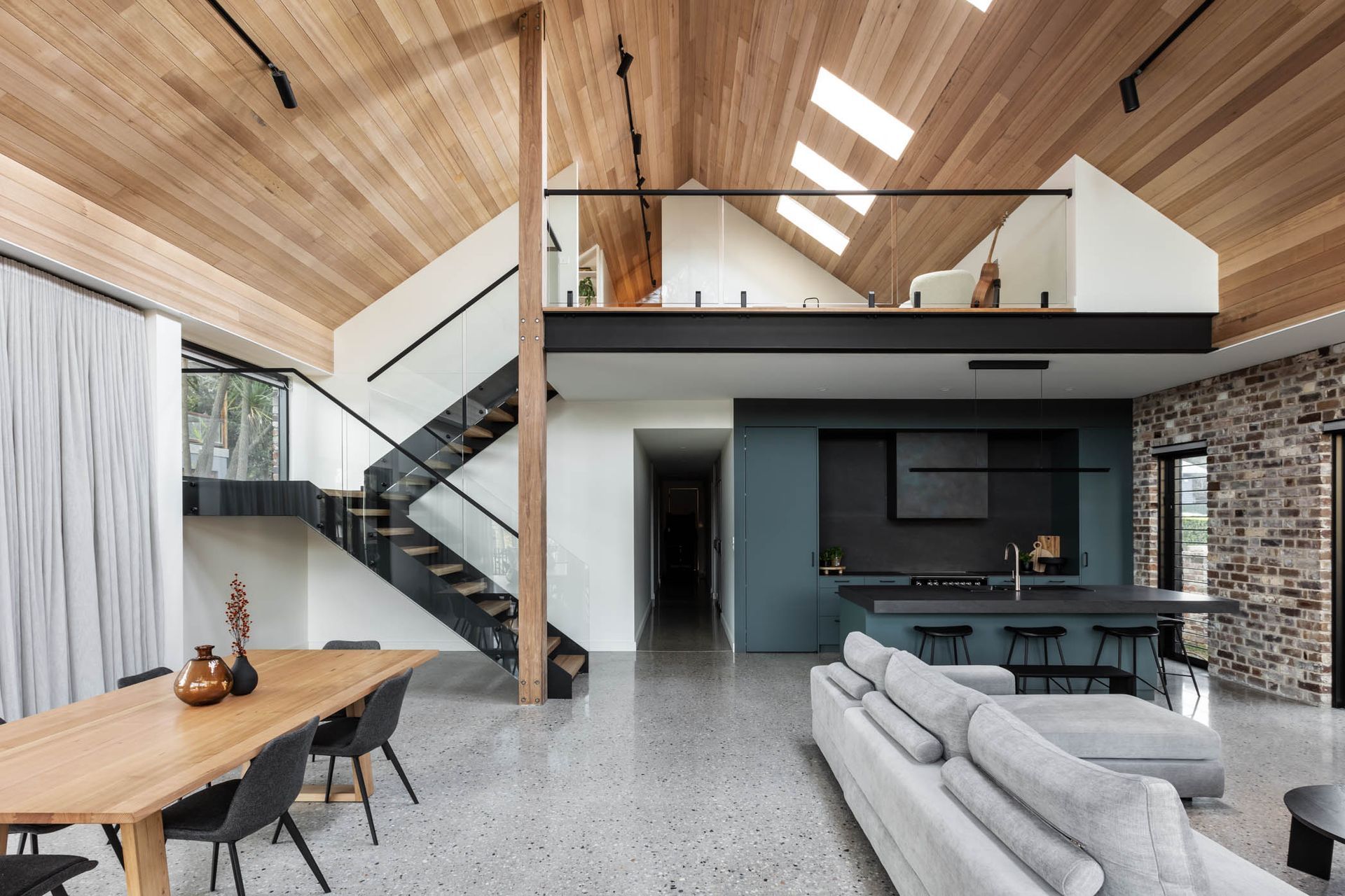 A touch of colour separates the kitchen in the otherwise muted palette.