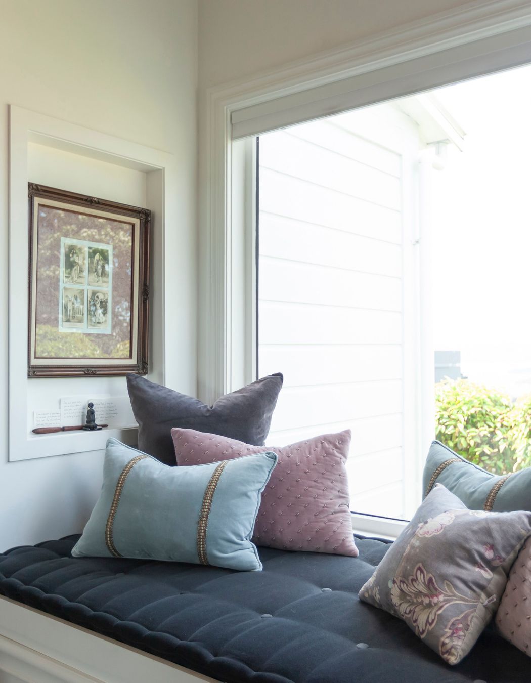 Aiken designed a window seat and a cavity in the bay window for artwork.