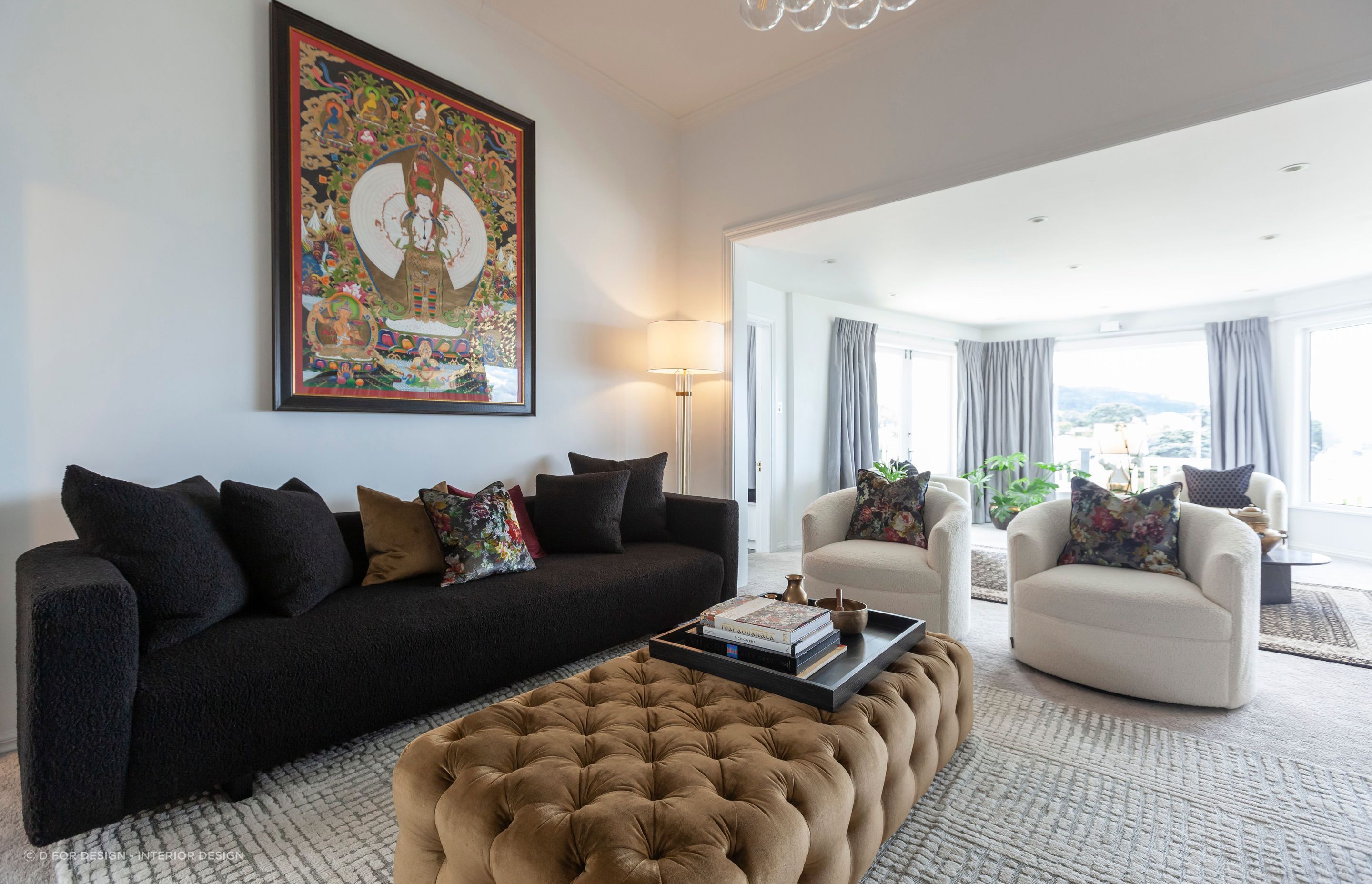 “The gold velvet of the ottoman also enhances the brass and gold elements around the living space and ties in with the gold in the Buddha print.”