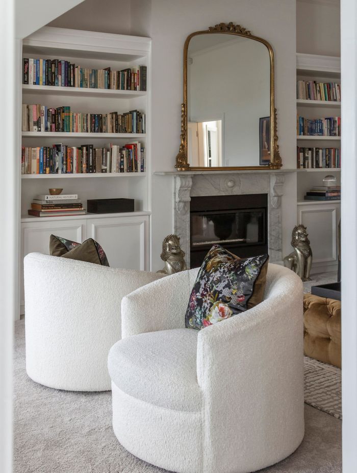 Two beautiful bookcases were custom-designed and manufactured to fit the cavities
on either side of the fireplace – a nod to Parisian style.