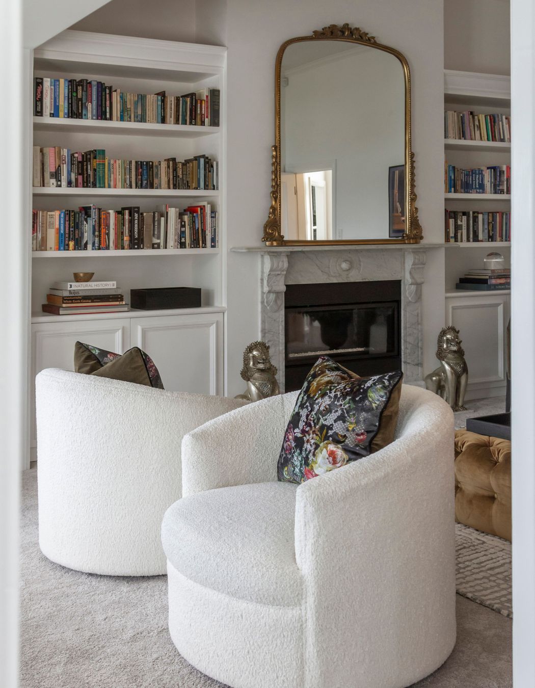 Two beautiful bookcases were custom-designed and manufactured to fit the cavities
on either side of the fireplace – a nod to Parisian style.