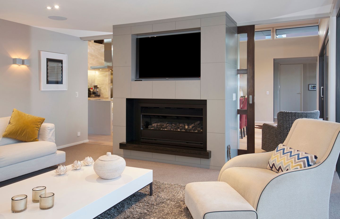 Separate from the open-plan kitchen and dining, the lounge area has a build-in fireplace.