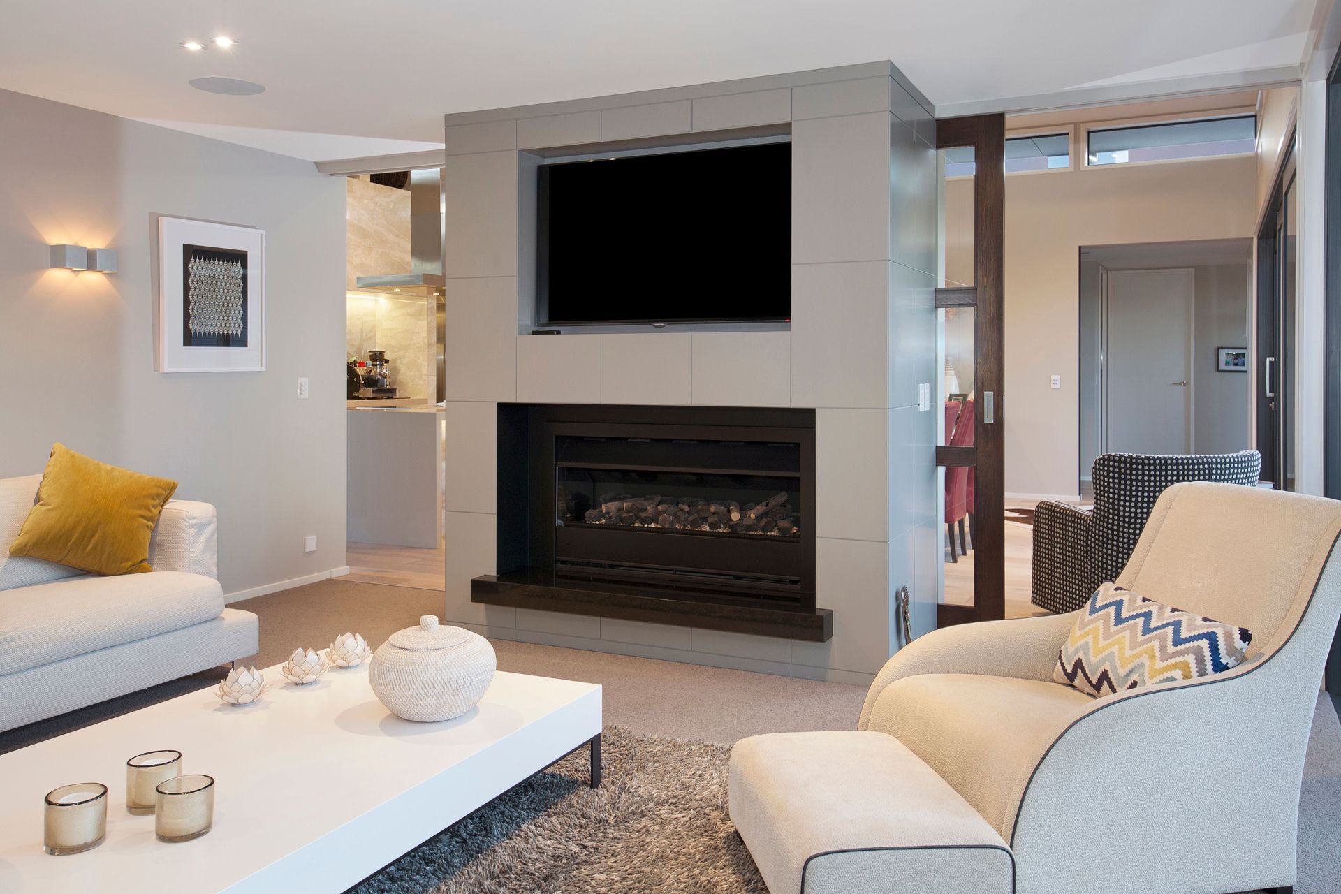 Separate from the open-plan kitchen and dining, the lounge area has a build-in fireplace.