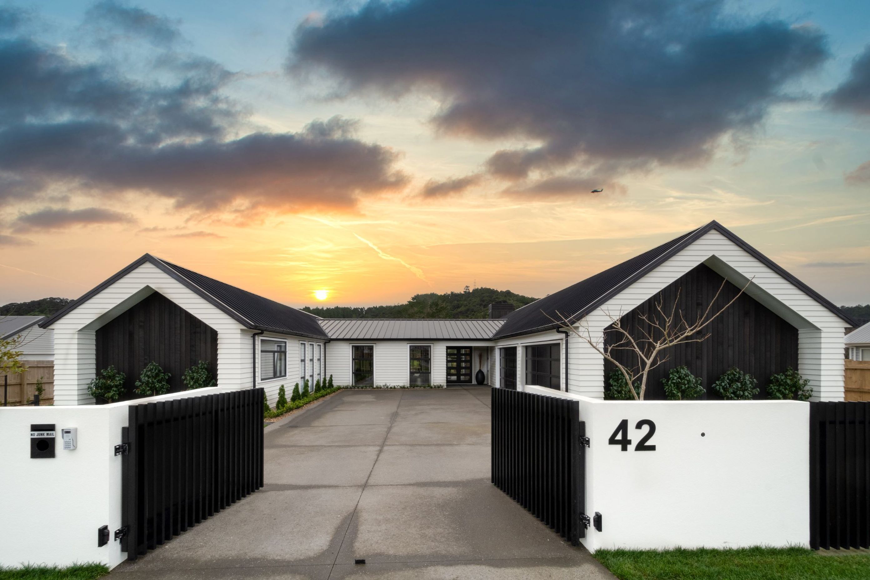 The bold double contrast between black and white combined with vertical and horizontal weatherboards makes an immediate impact at 42 Fruitland Road in Huapai. | Photography: Danilo Dijamco