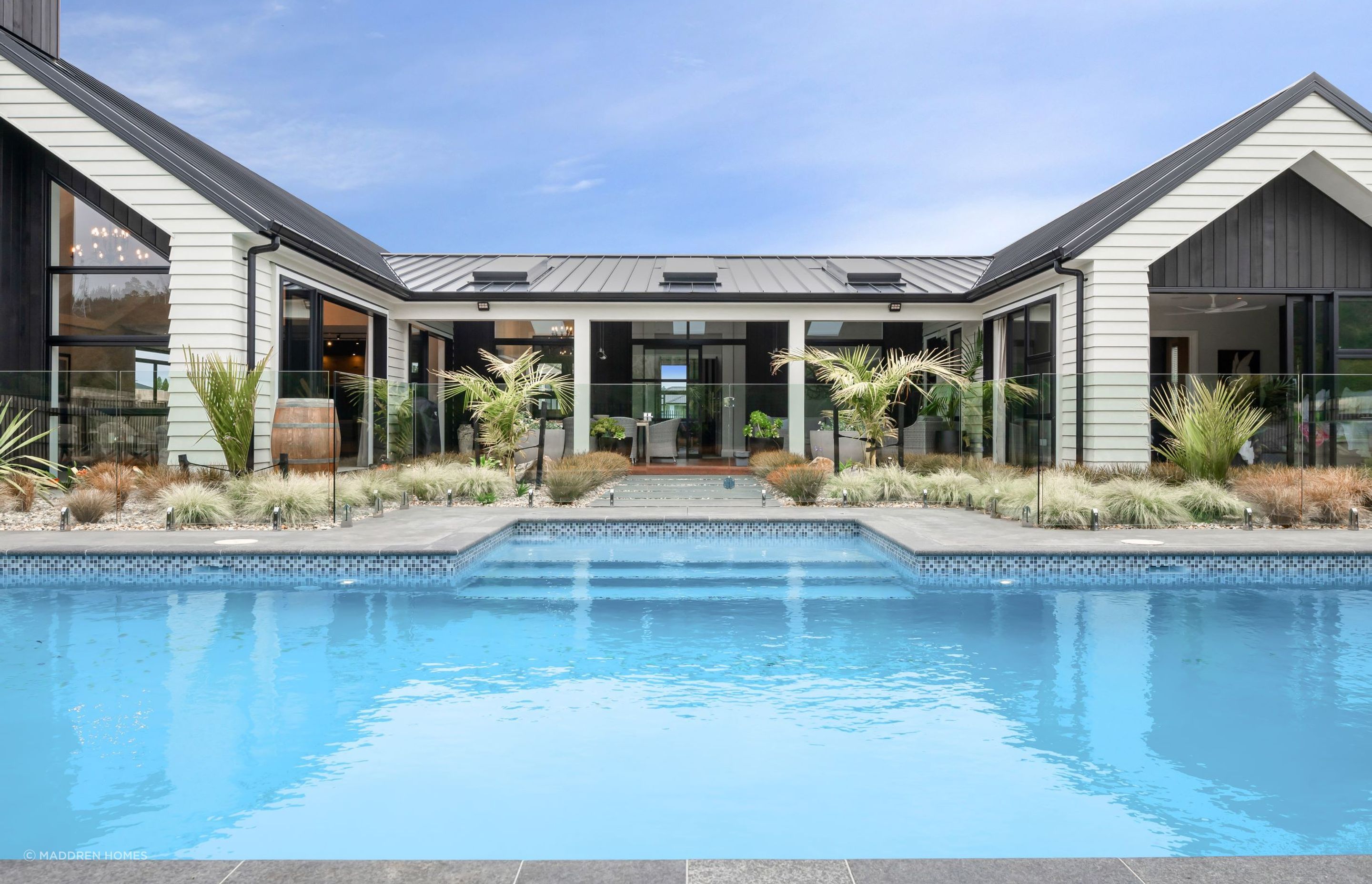 A lavish and luxurrious swimming pool is one of many highlights in this outdoor living space. | Photography: Danilo Dijamco