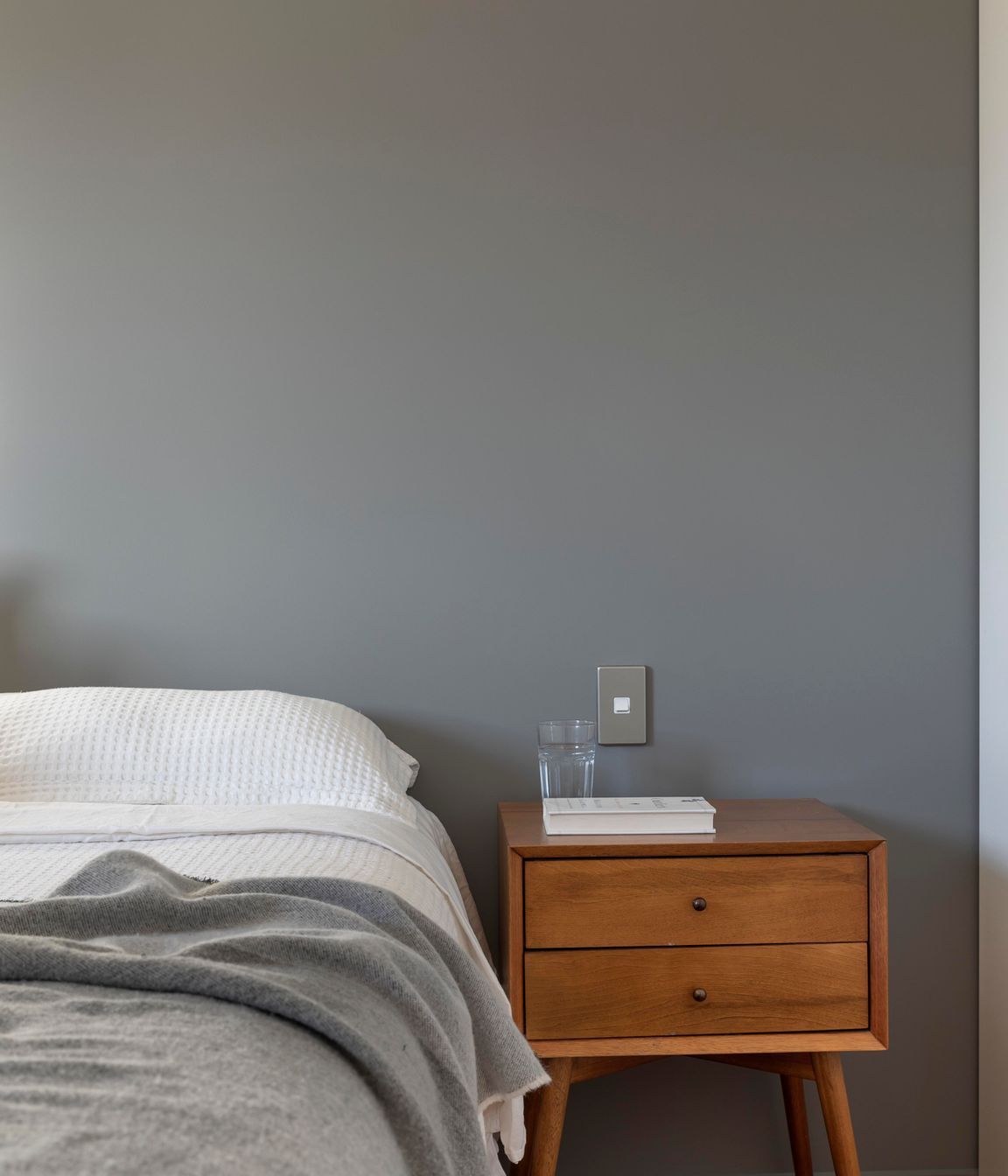 Deep greys are calming in the bedroom.