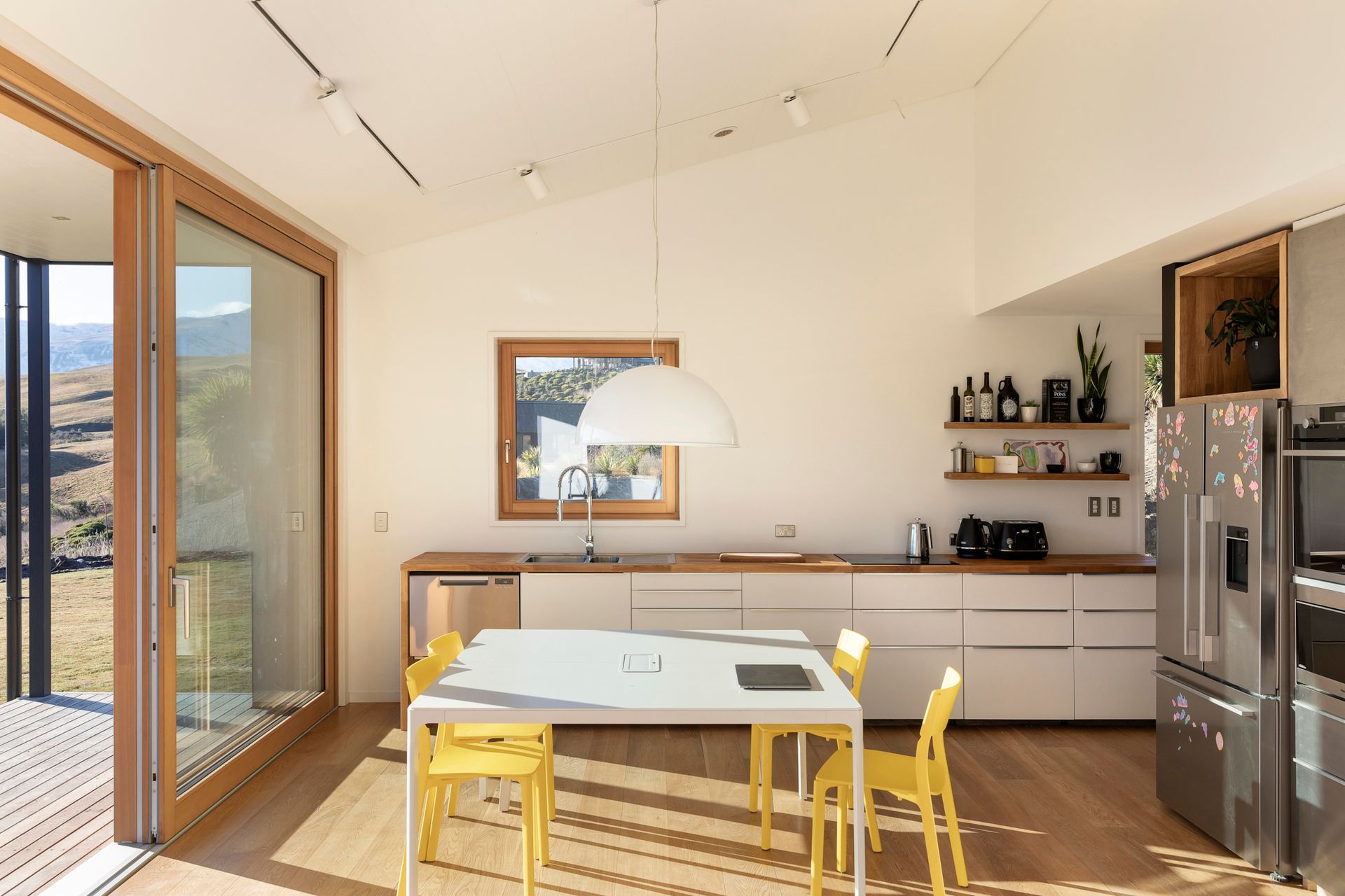 The living, kitchen, and dining area extends onto a deck.