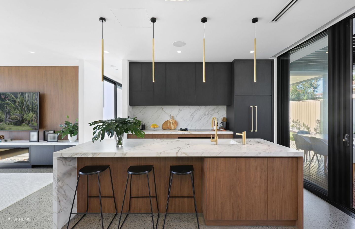 A matching backsplash and island bench featuring sublime Grande Max Golden White slabs in this open plan design at Feilberg Place - Photography: DIB CHIDIAC