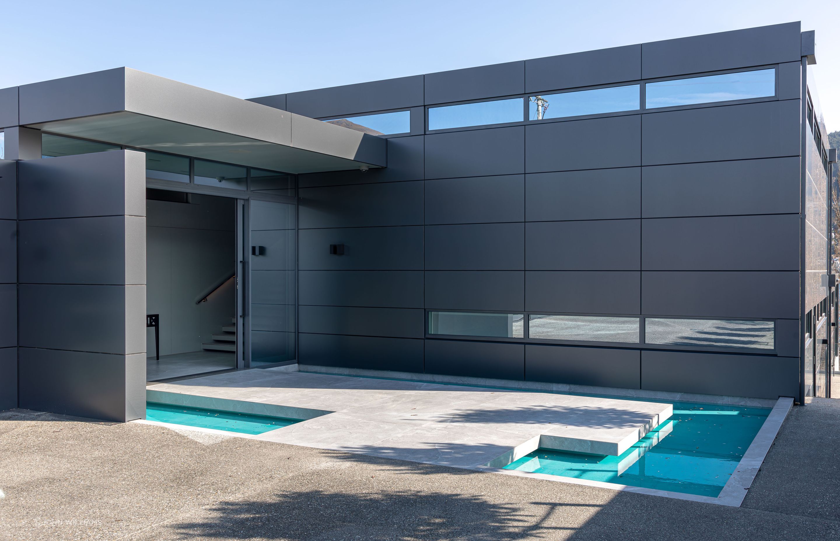 At the main entrance, a raised platform hovers over a pond, prompting a moment of reflection before continuing inside. The “reflection pond” is the first in a series of architectural water features curated to form a journey of sensory exploration.