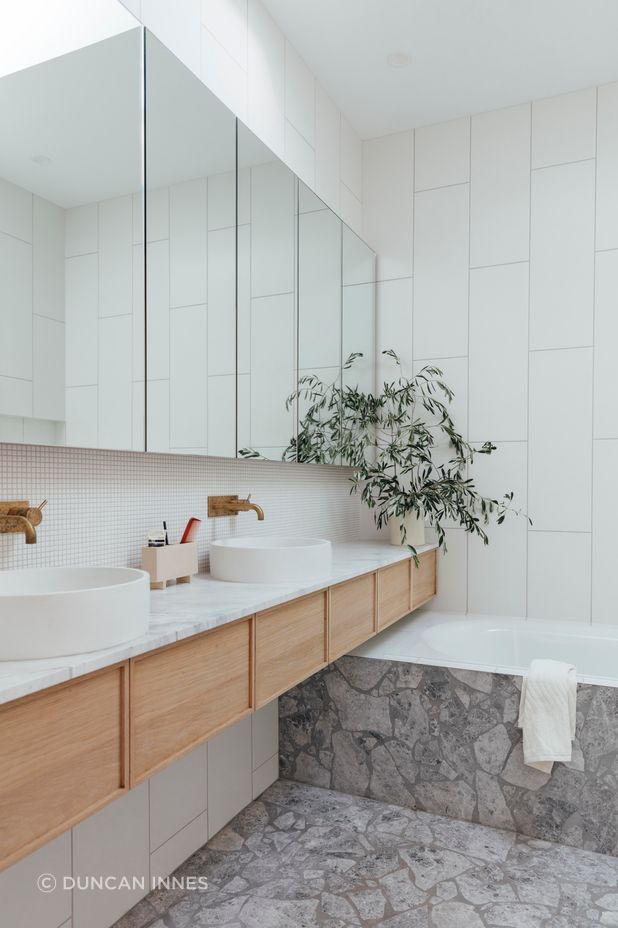 An ensuite uses a light, fresh material palette.