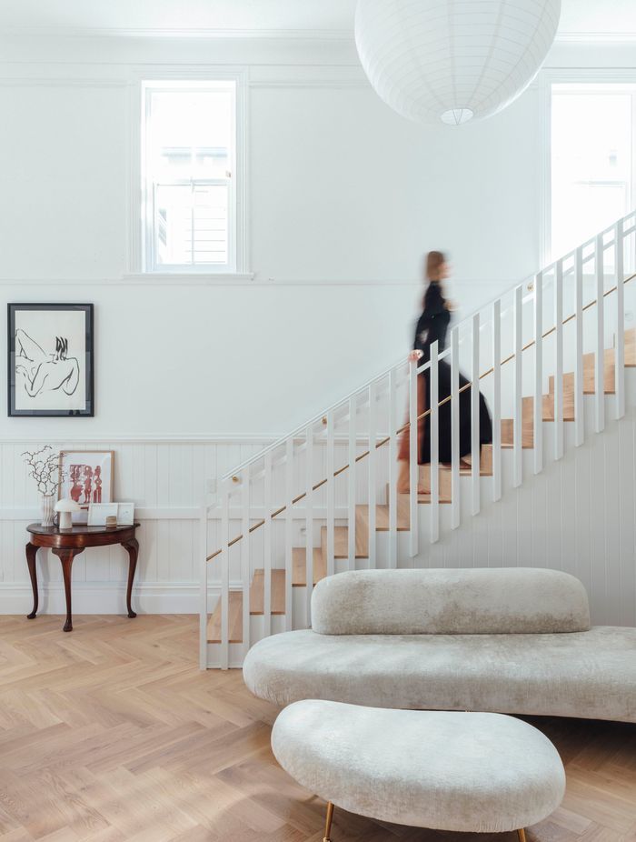 A timber screen marks the stairs leading up to the primary bedroom in the northwestern corner of the main hall.
