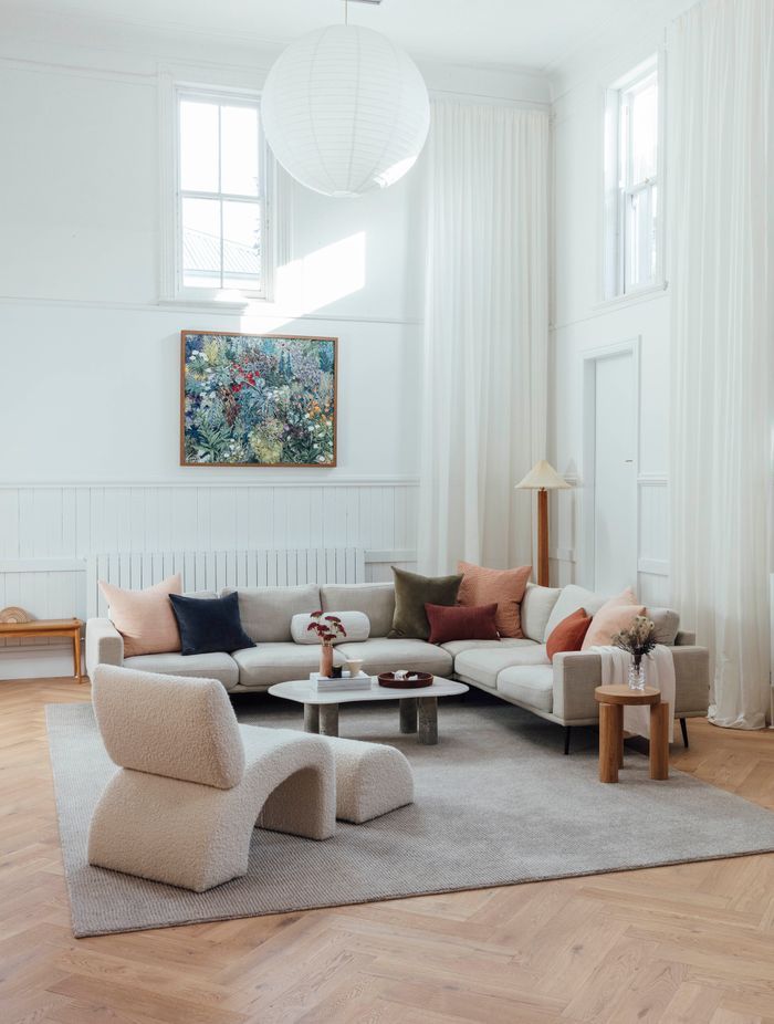 Swathes of clean, white paint cover walls to reflect natural light, softened by the warmth of herringbone oak flooring and restored original brickwork.