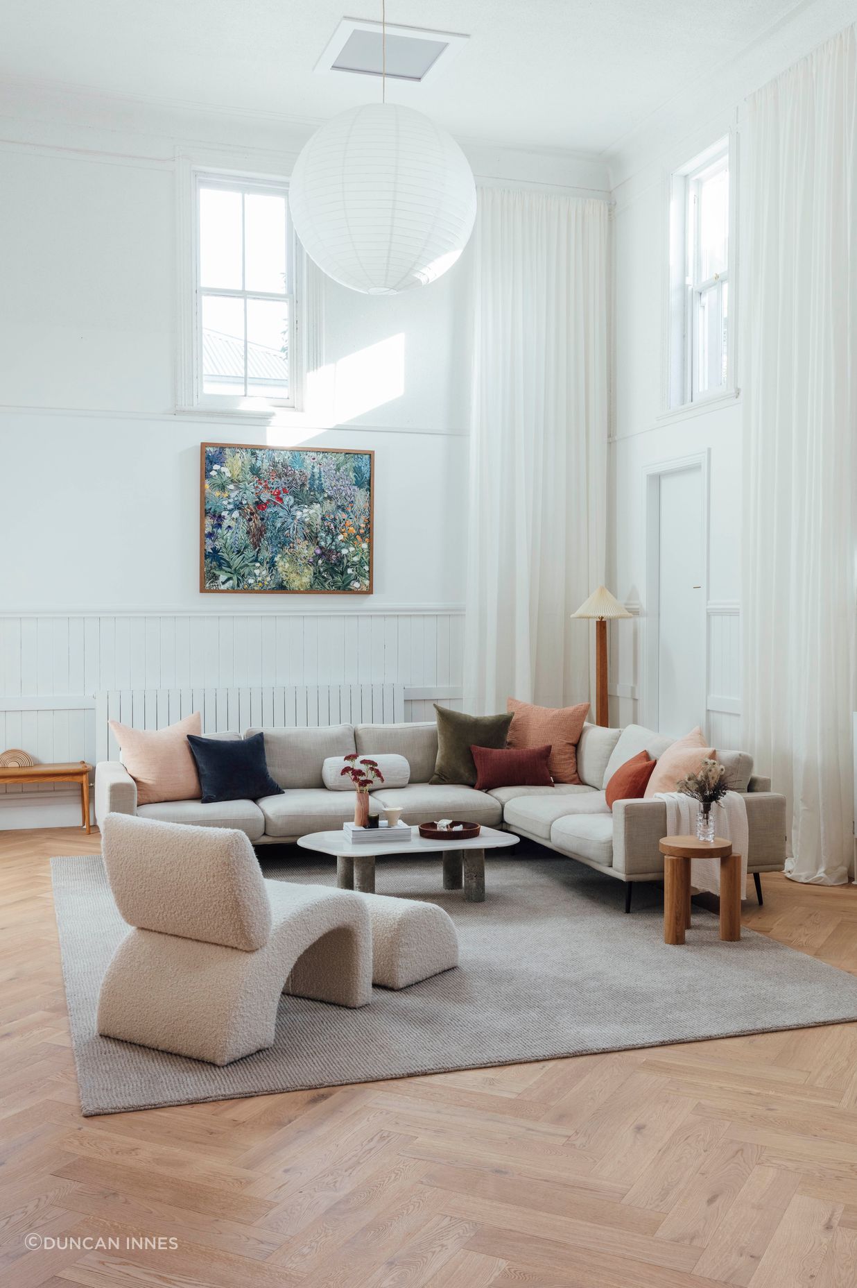 Swathes of clean, white paint cover walls to reflect natural light, softened by the warmth of herringbone oak flooring and restored original brickwork.