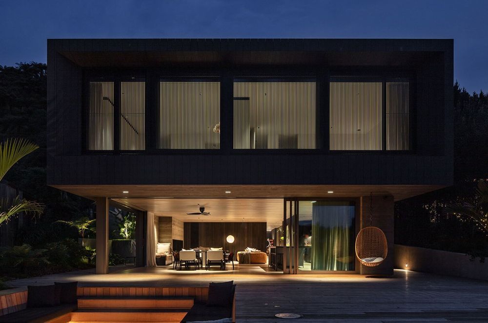 Sam and Fiona Fillmore’s lakehouse on the edge of Lake Rotoiti was designed by Evelyn McNamara of Evelyn McNamara Architecture. The ground-level glass doors open completely to welcome and provide a connection to Sam’s childhood bach next door.