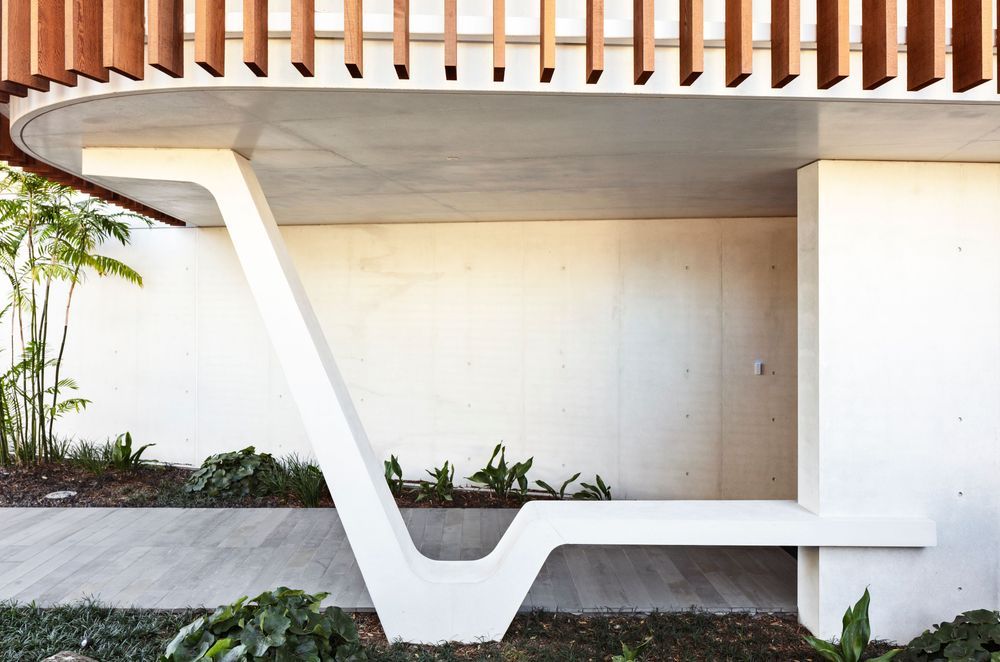 Outside, the white concrete contrasts with cedar accents.