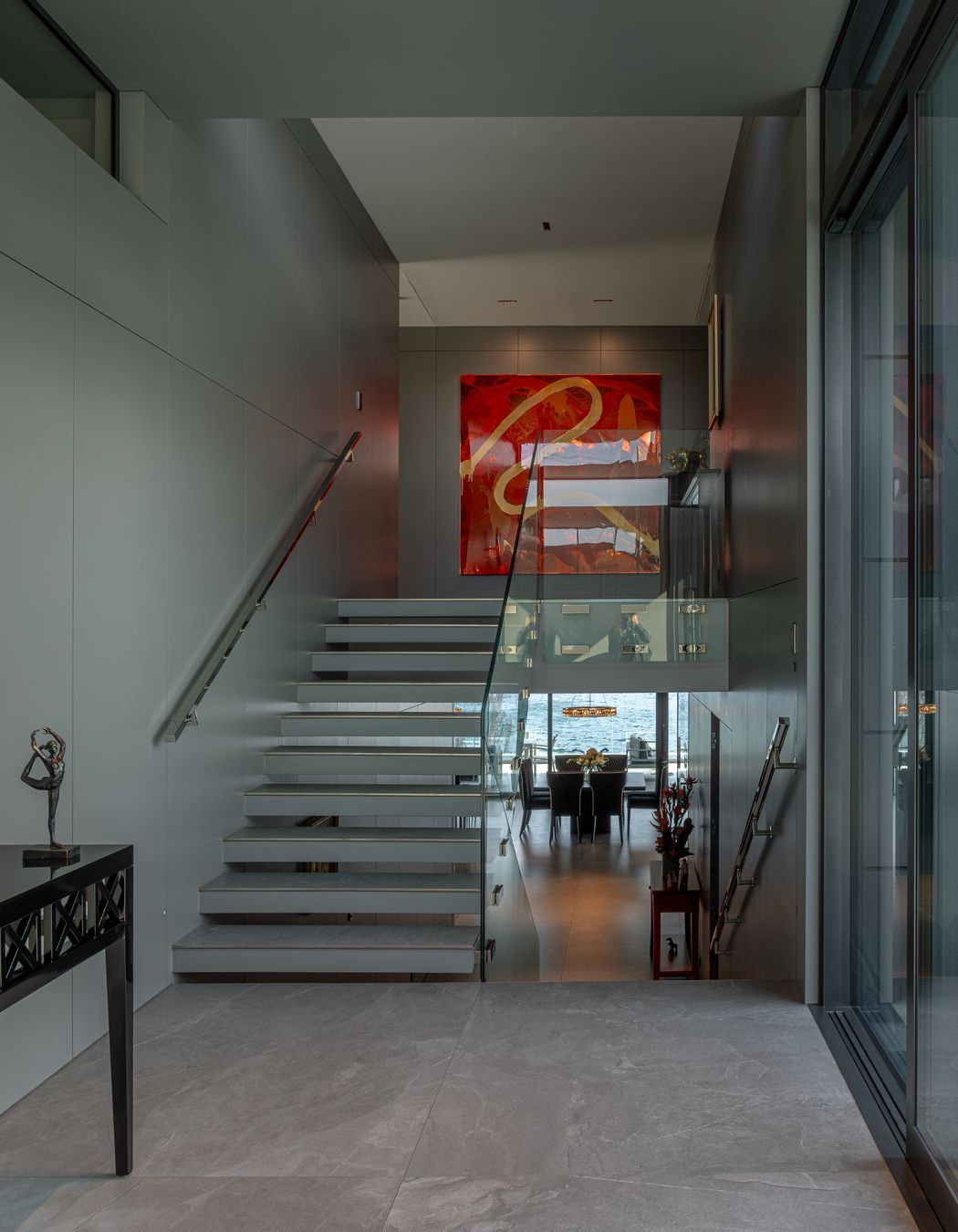 In the foyer, staircases seem to float, and bannisters glow, backlit by LED lights.