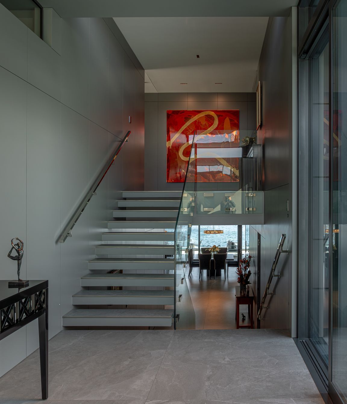 In the foyer, staircases seem to float, and bannisters glow, backlit by LED lights.