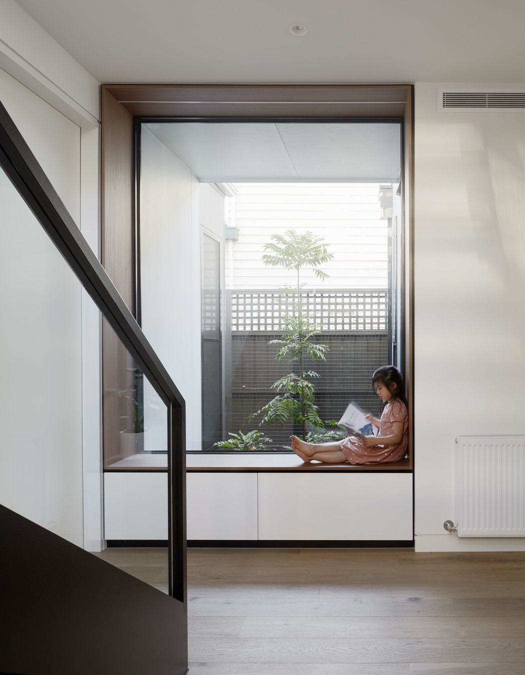 A reading nook with a large window overlooking an internal courtyard has been added where the extension meets the front of the home.