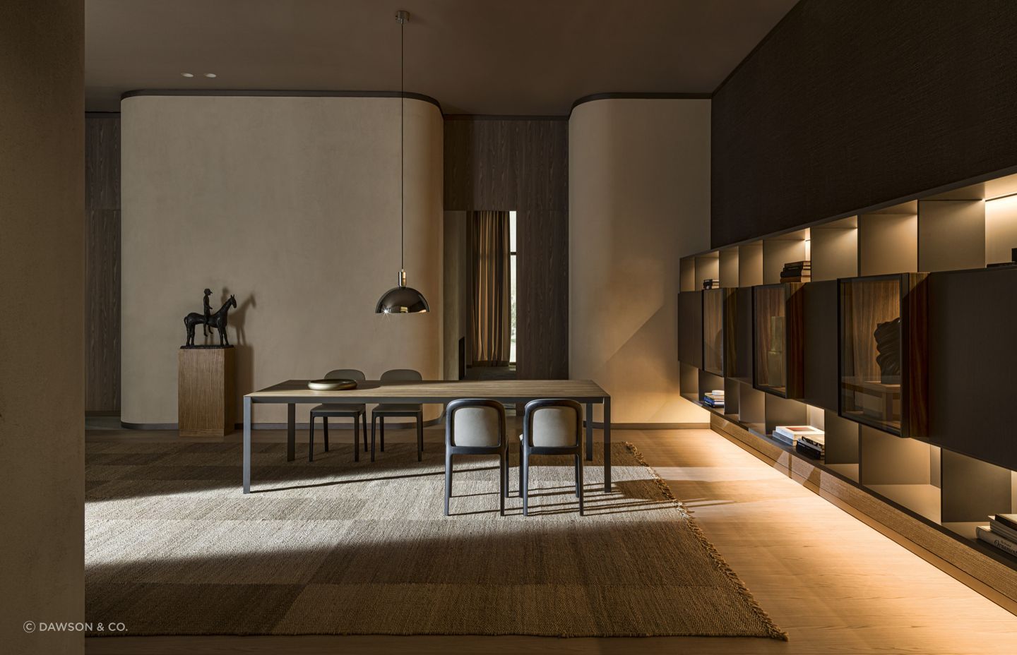 Statement rugs can provide a layer of comfort and style on hardwood surfaces, seen here with the exquisite Half A Square Dining Table by Molteni&amp;C.