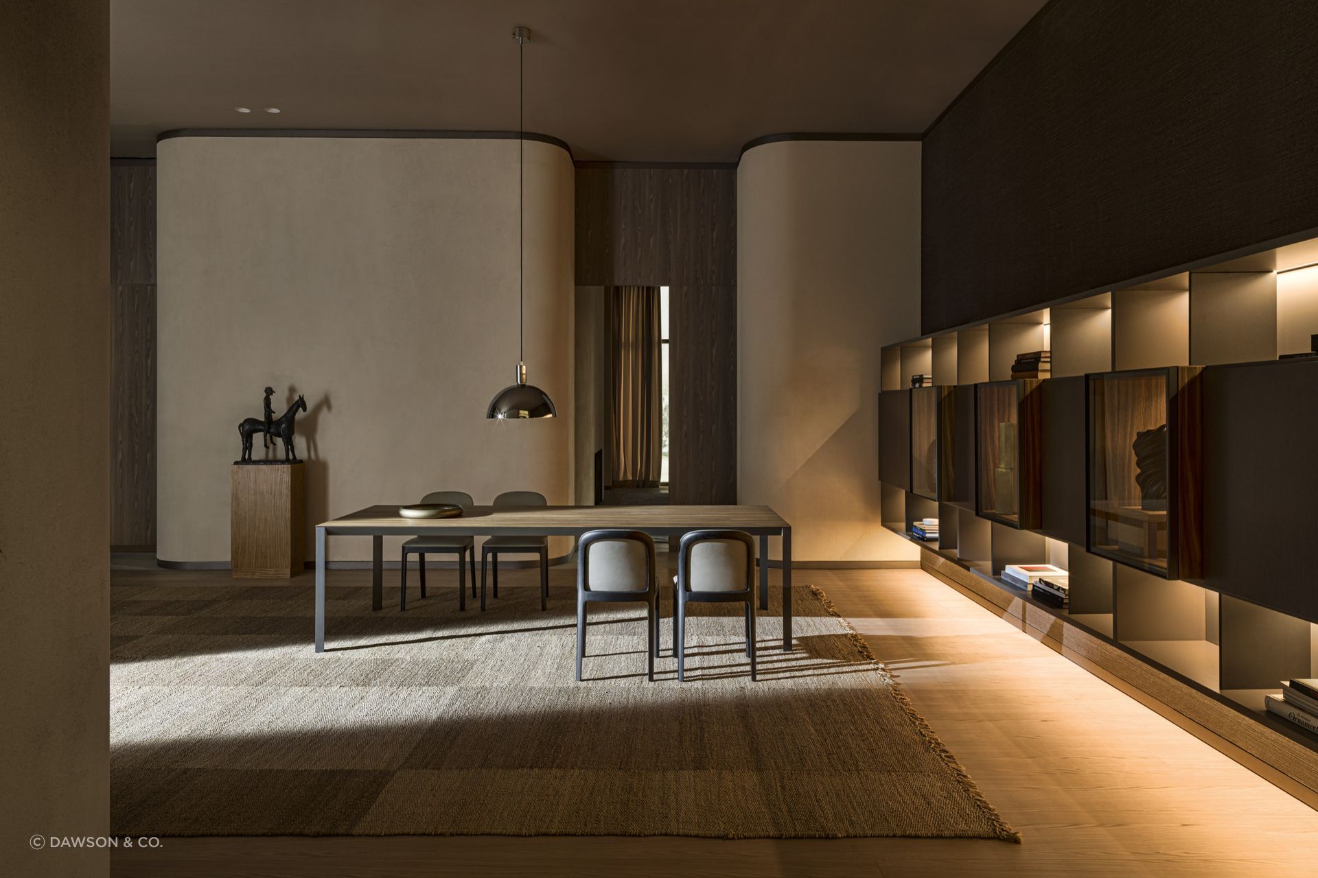 Statement rugs can provide a layer of comfort and style on hardwood surfaces, seen here with the exquisite Half A Square Dining Table by Molteni&amp;C.