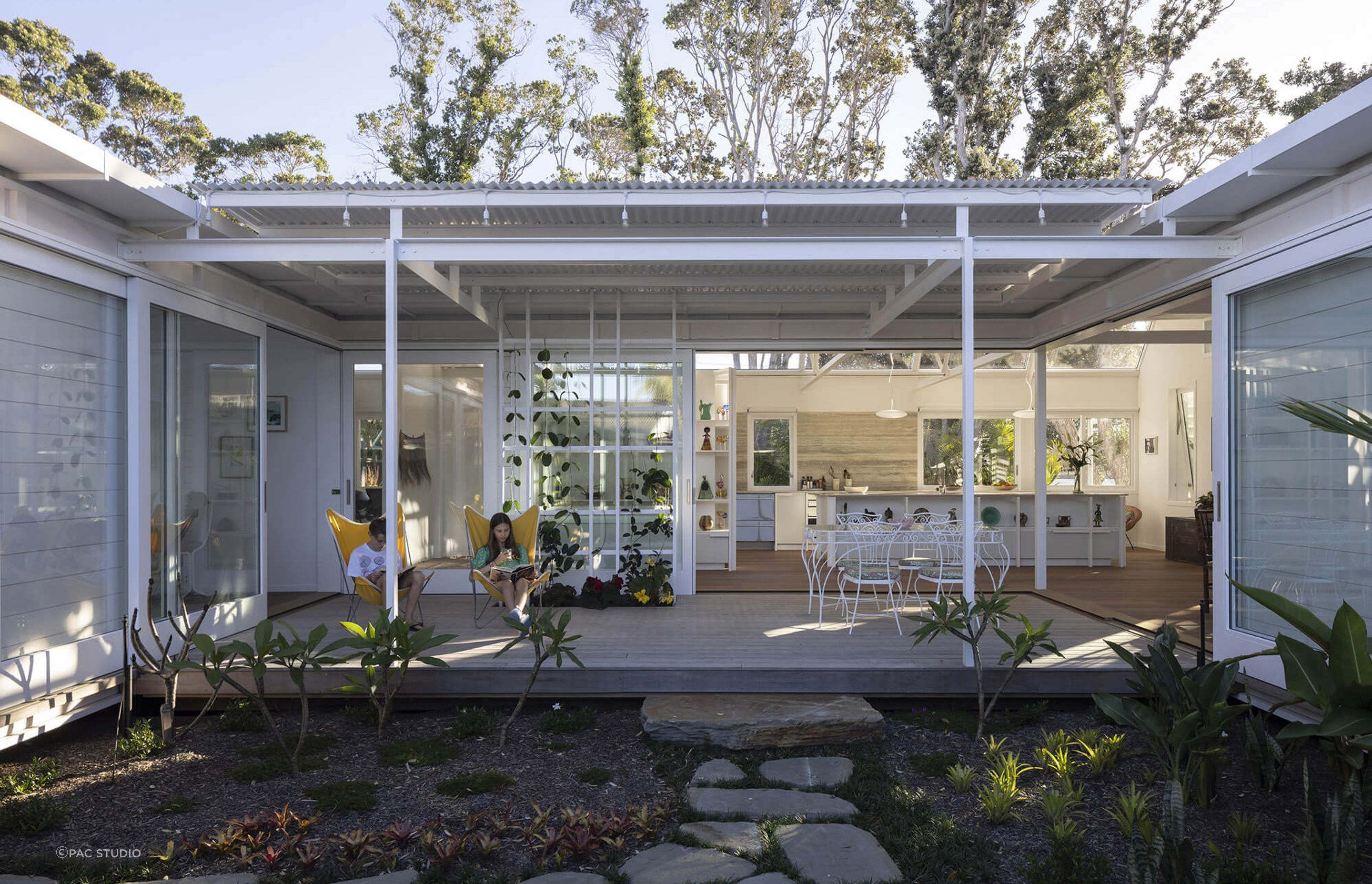 Large sliding doors seamlessly connect the indoor and outdoor living spaces.