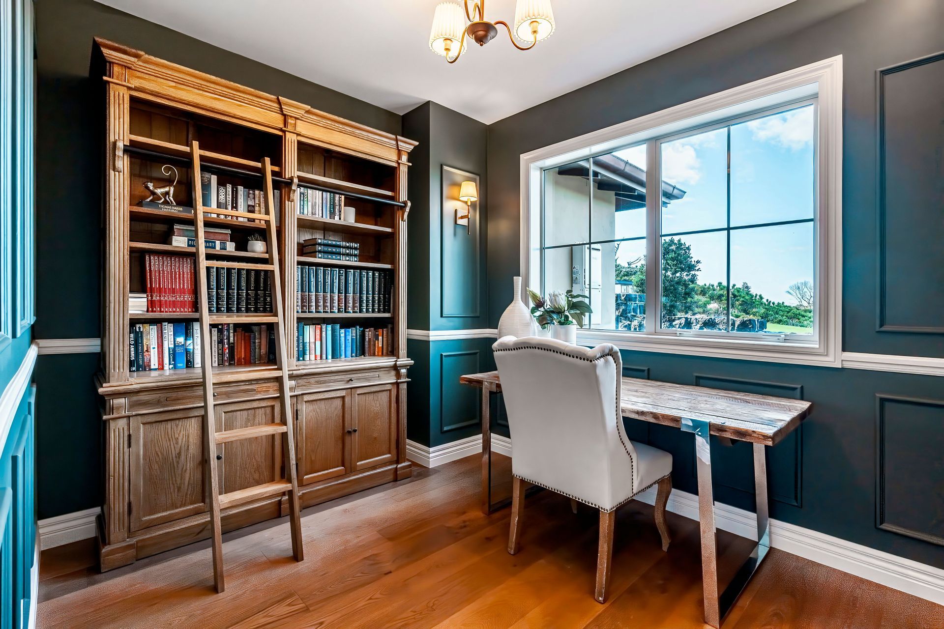 With dark walls and a beautiful bookshelf with ladder access, the study space has become a favourite part of the home.