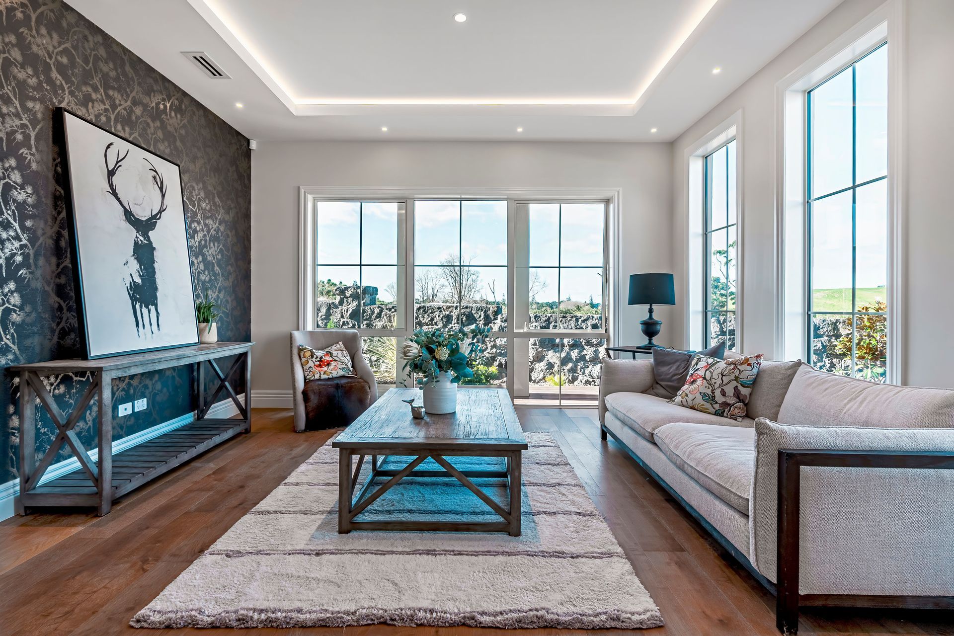Natural light enters the sitting room. At night, the recessed ceiling lights create a relaxed atmosphere.