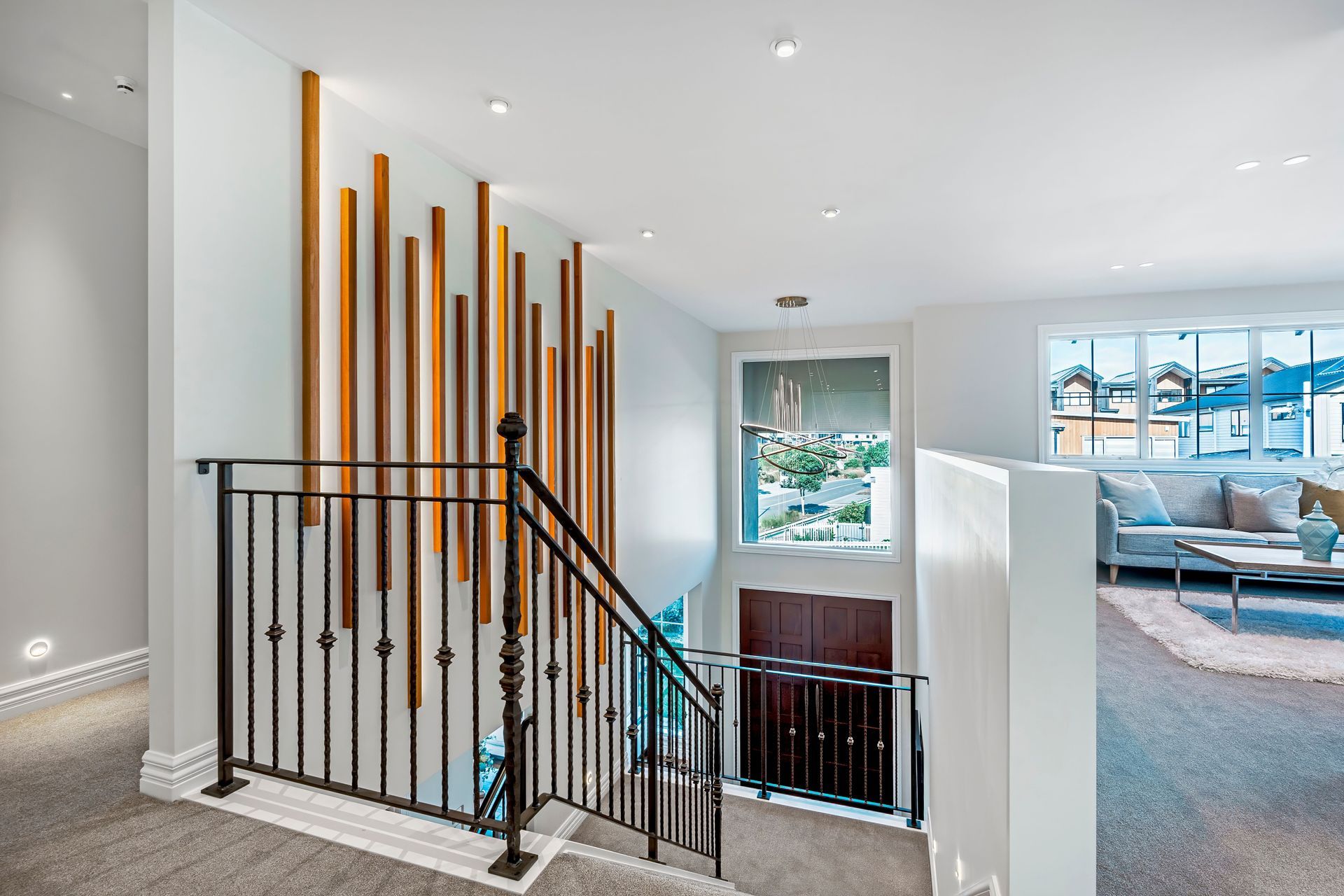 The staircase features an ornate iron balustrade.