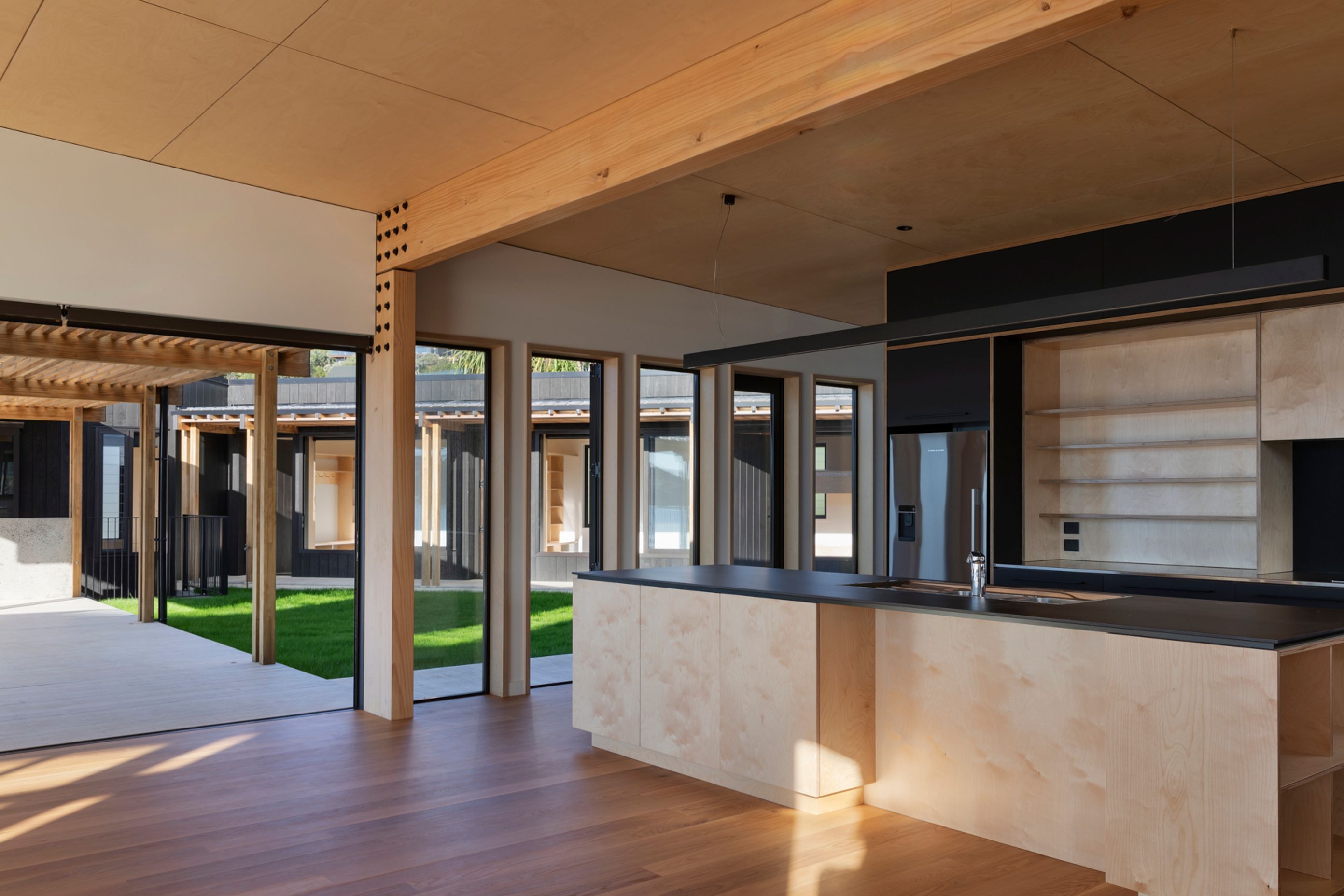 The ceilings and kitchen cabinets are birch ply by Plytech. The benchtops are Neolith porcelain from SCE Stone &amp; Design.