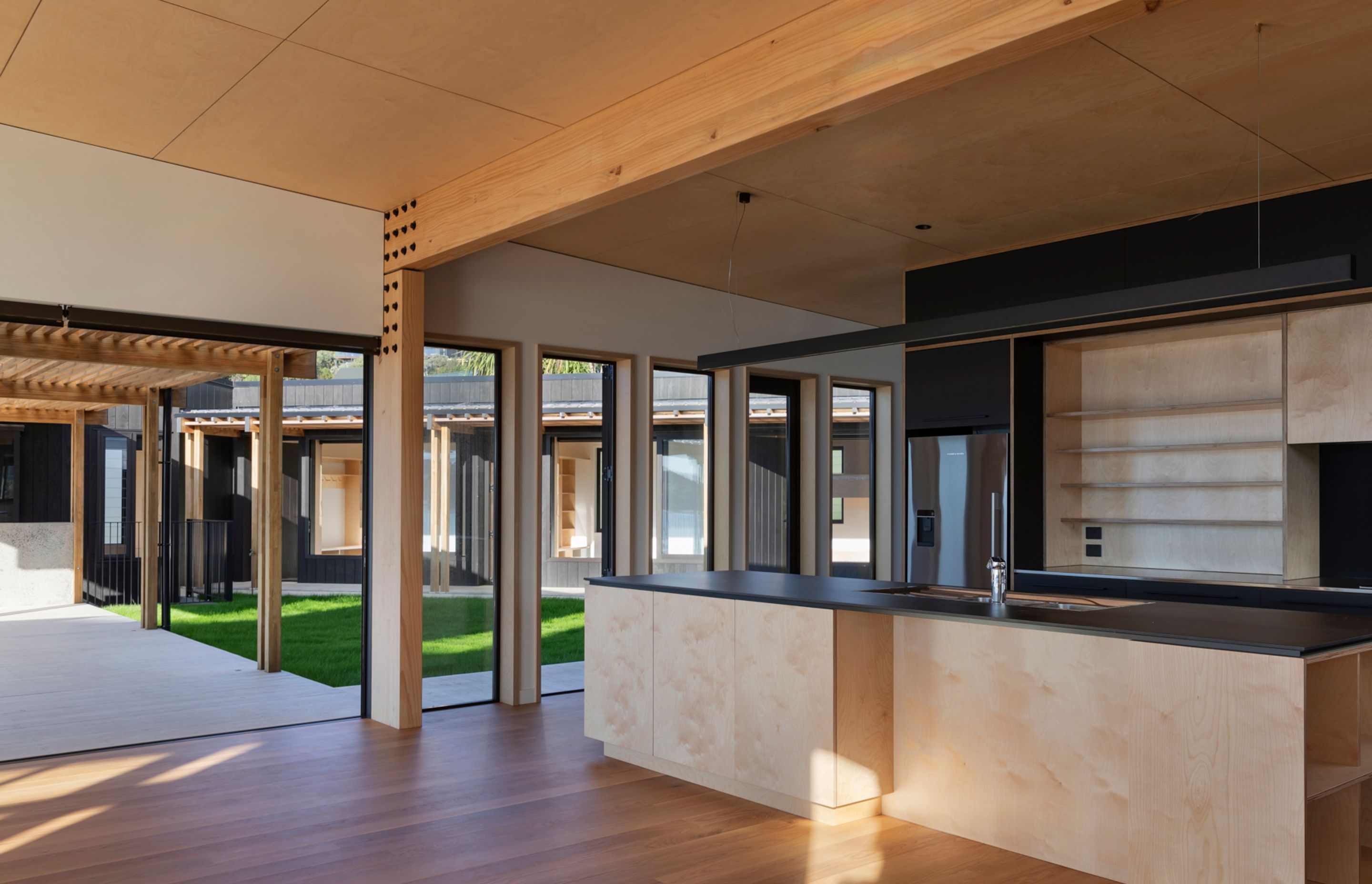 The ceilings and kitchen cabinets are birch ply by Plytech. The benchtops are Neolith porcelain from SCE Stone &amp; Design.