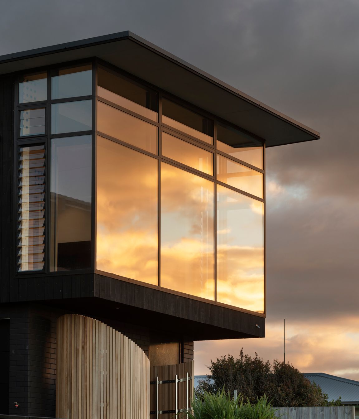 The curved structure is made of Accoya slats and contains an outdoor shower for when the family comes up from the beach.