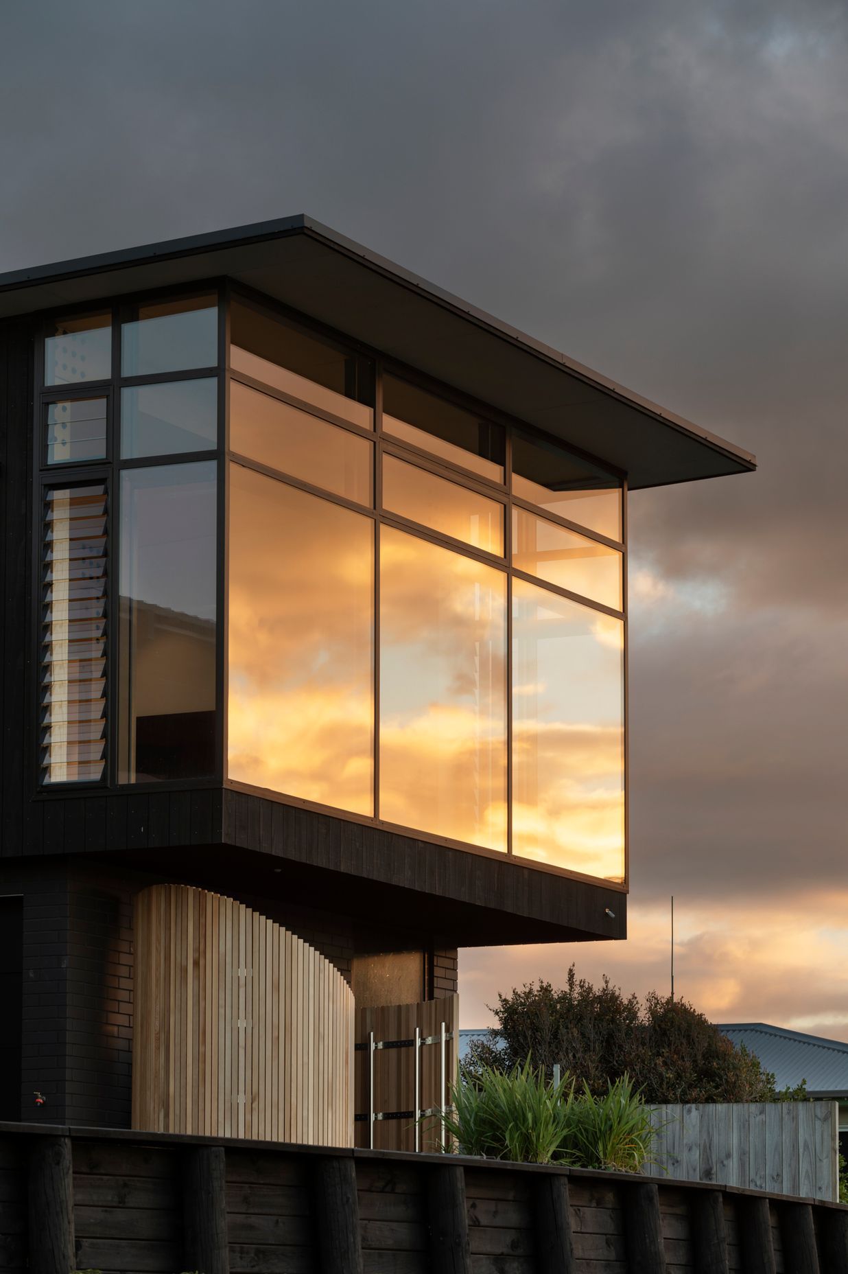 The curved structure is made of Accoya slats and contains an outdoor shower for when the family comes up from the beach.