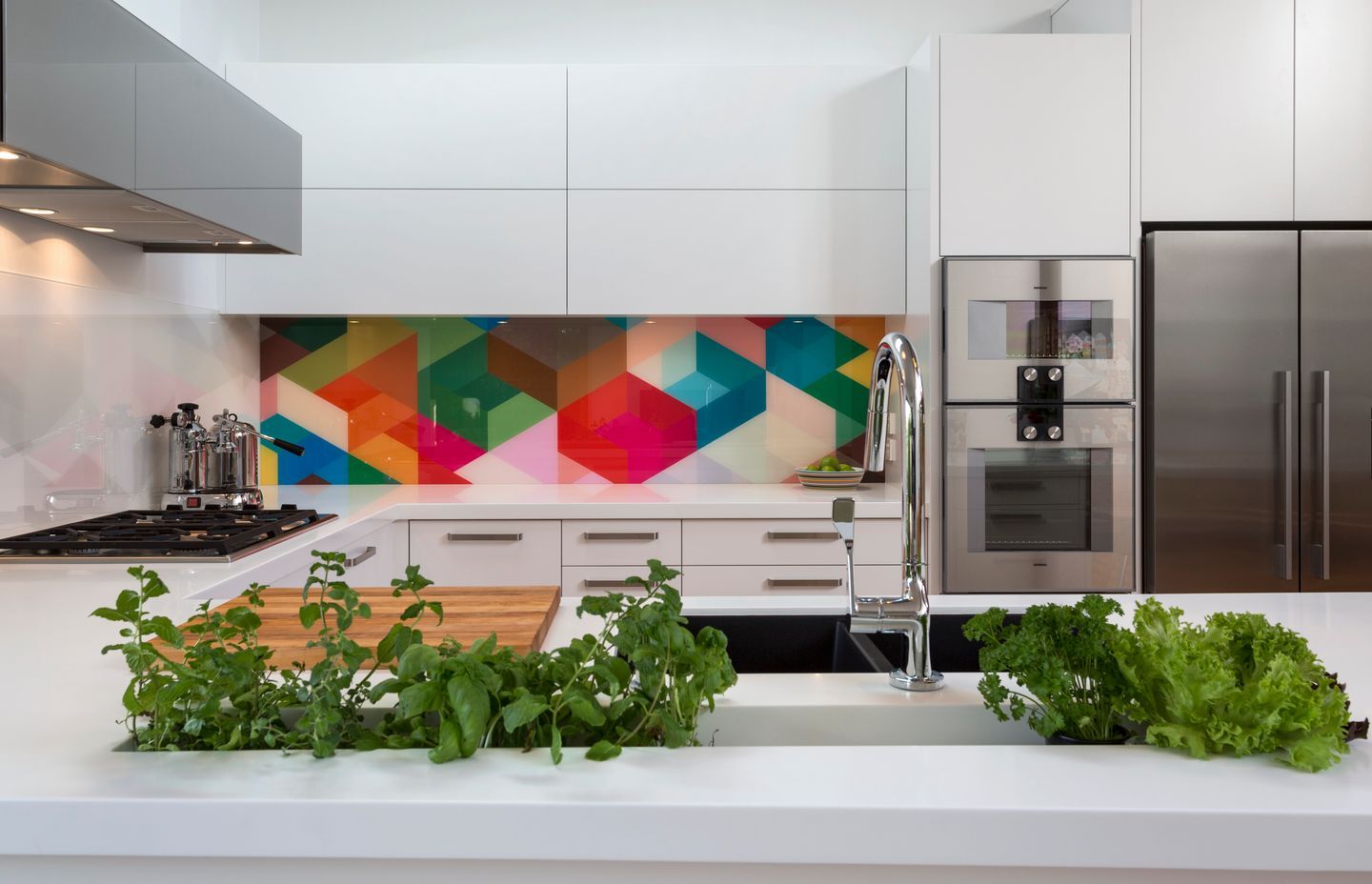 Geometric colour and adjacent geometric monochrome work harmoniously in this white kitchen. Kitchen by Kitchen Architecture