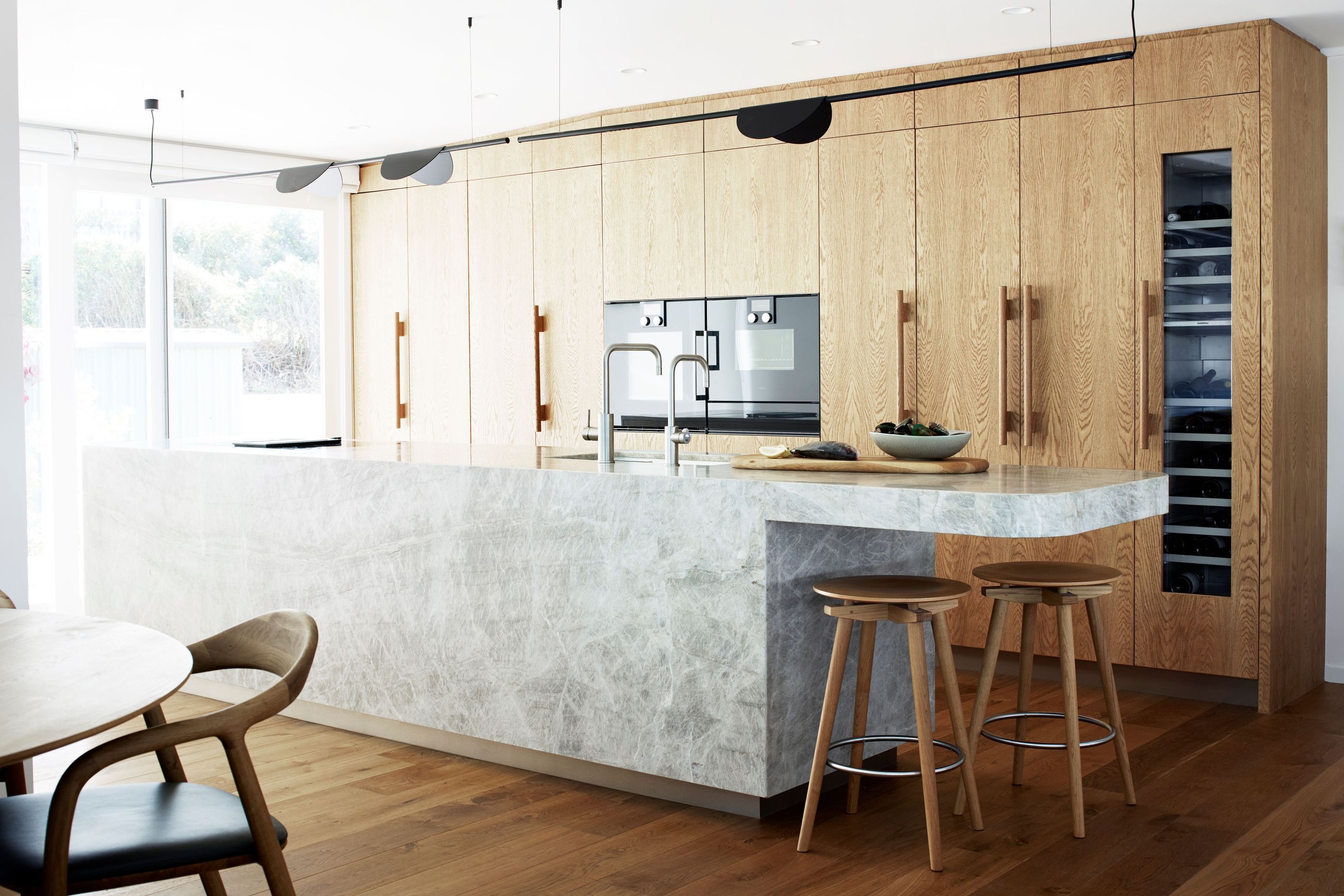The kitchen in this Leigh holiday home, renovated by Natalie Du Bois of Du Bois Design. The original kitchen was a U-shaped configuration and tucked into an alcove. Natalie opted instead to open up to the living area in a galley style.