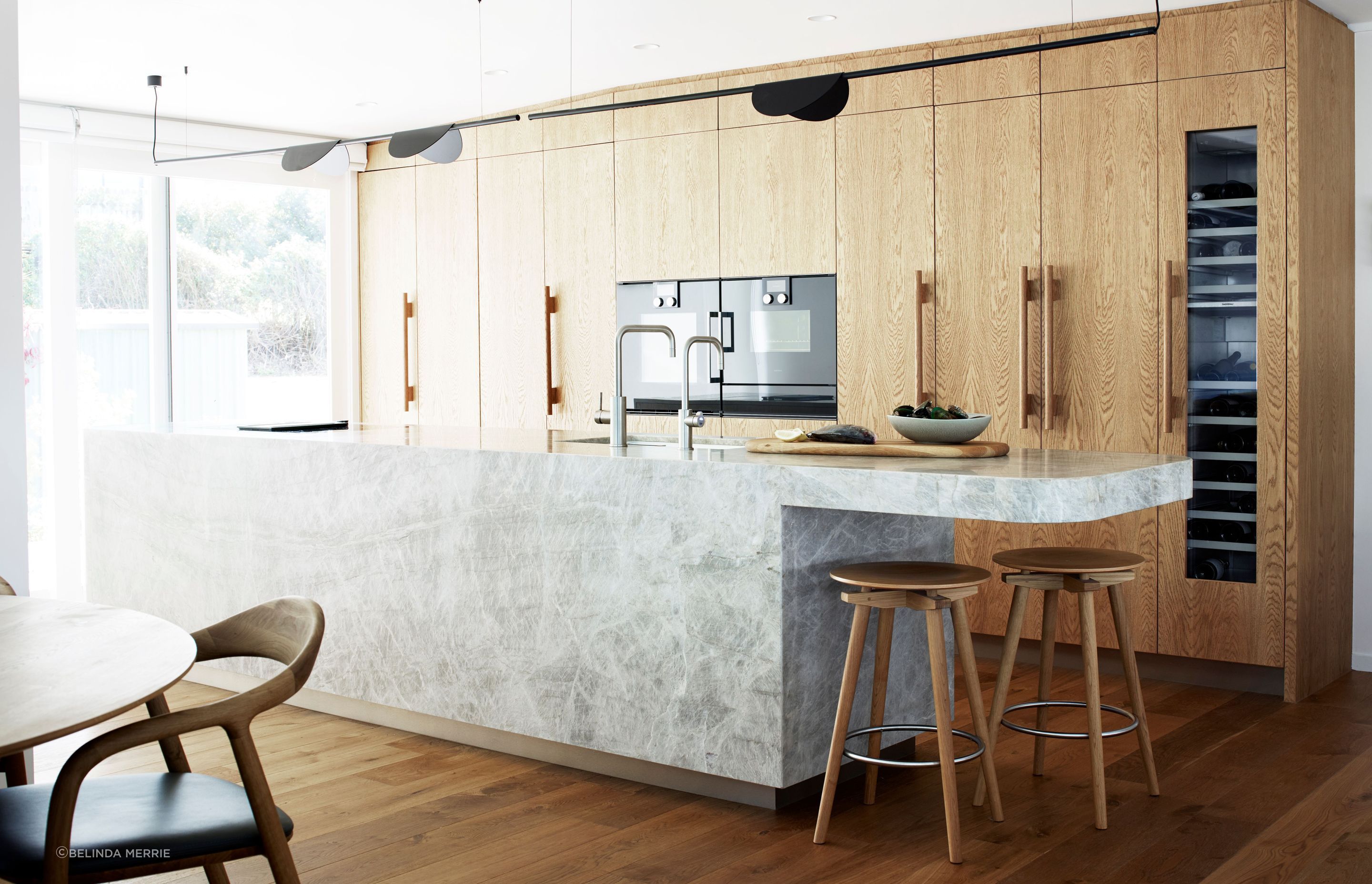 The kitchen in this Leigh holiday home, renovated by Natalie Du Bois of Du Bois Design. The original kitchen was a U-shaped configuration and tucked into an alcove. Natalie opted instead to open up to the living area in a galley style.