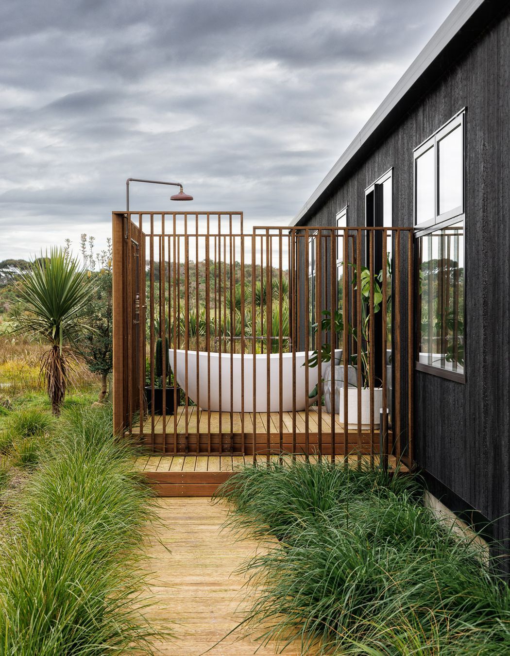 The hallway links to bedrooms, living spaces, and a bathroom with an outdoor bath.