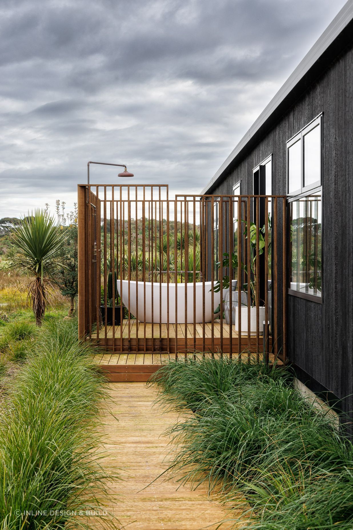 The hallway links to bedrooms, living spaces, and a bathroom with an outdoor bath.