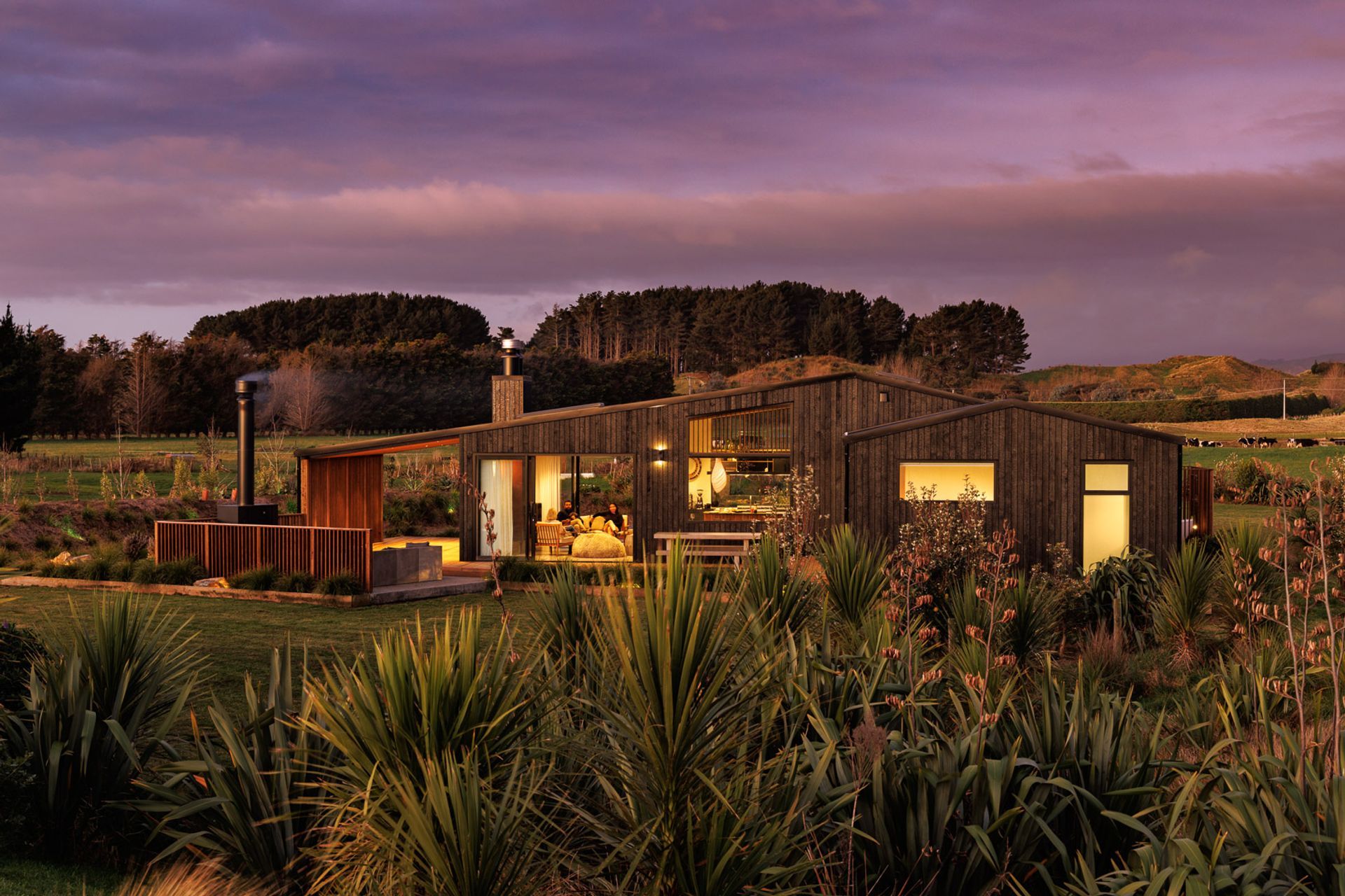 The site is surrounded by verdant fields and framed by the silhouettes of mountains.