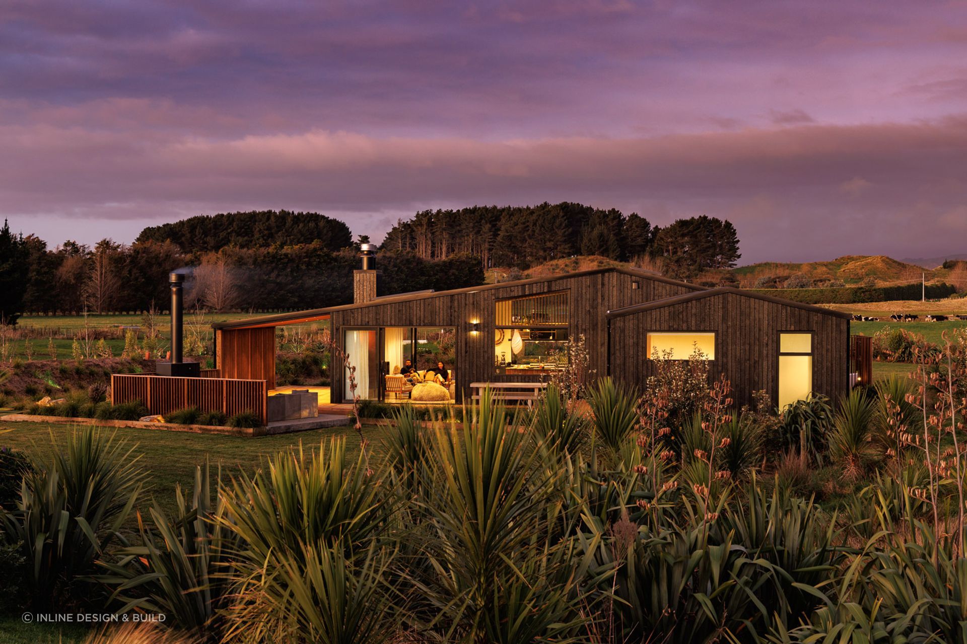 The site is surrounded by verdant fields and framed by the silhouettes of mountains.