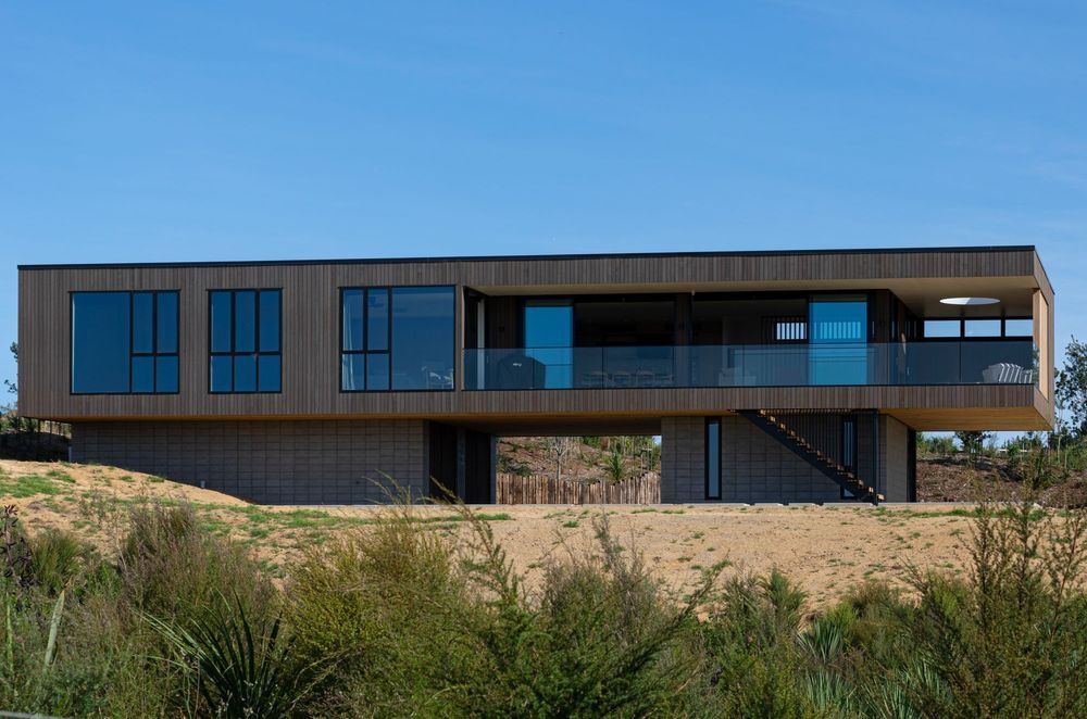 Decks to the north and west are carved out of the simple rectangular box form.