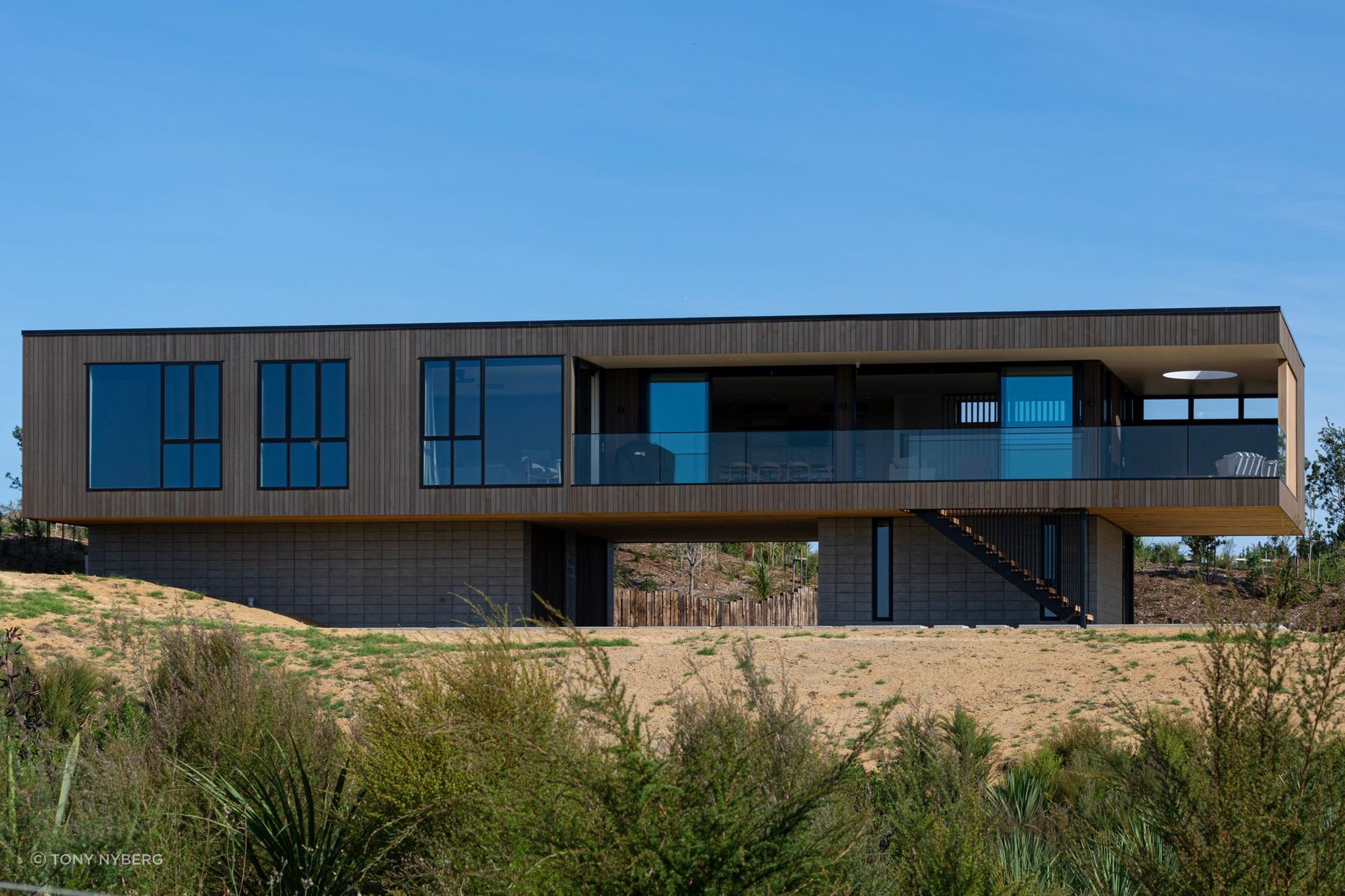 Decks to the north and west are carved out of the simple rectangular box form.