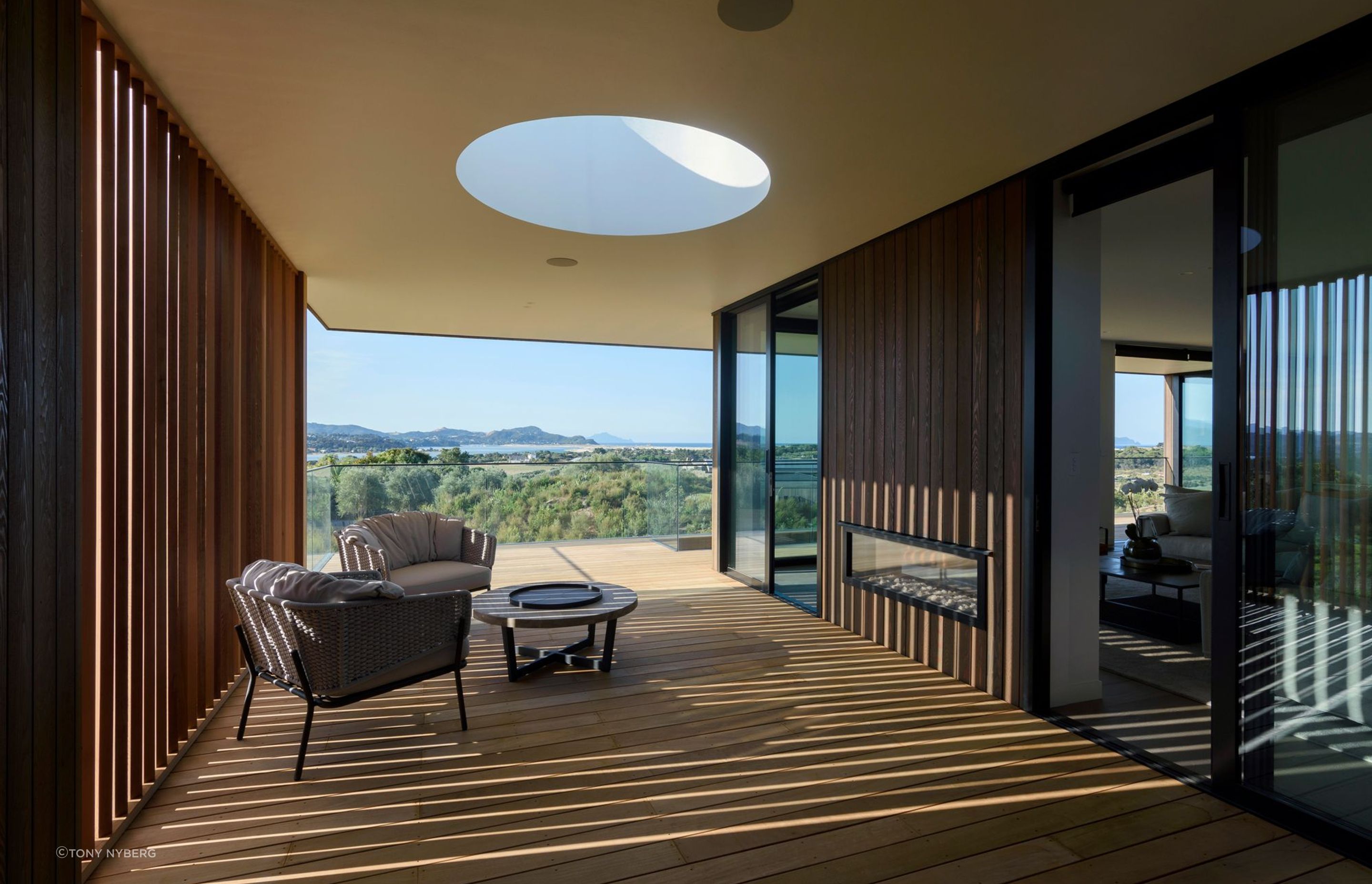 A skylight above the western deck draws light into the area while cedar fins create changing patterns throughout the day.