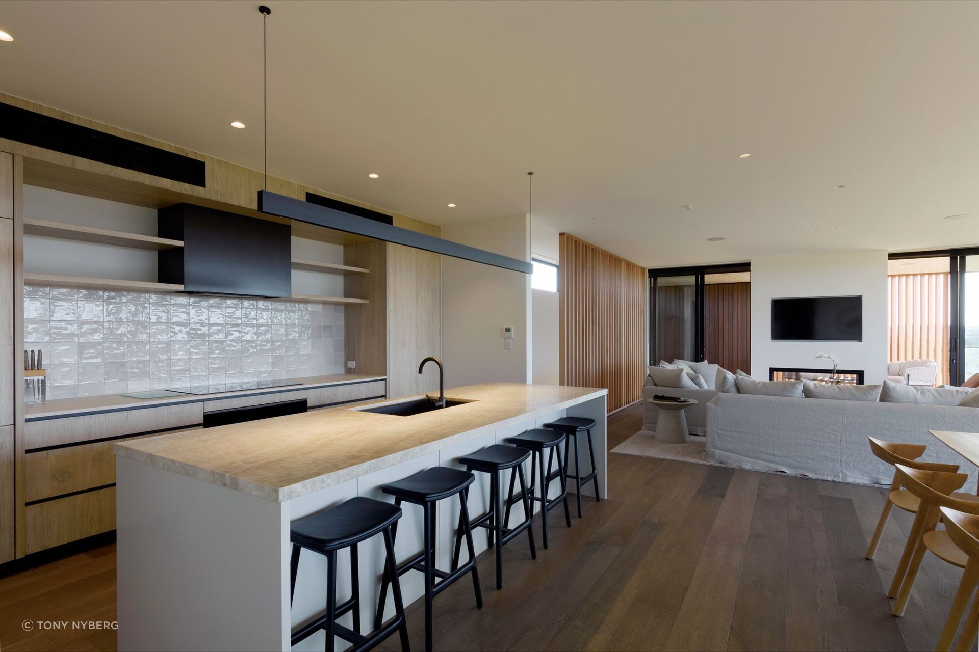 The colour and material palette enhances the coastal setting.