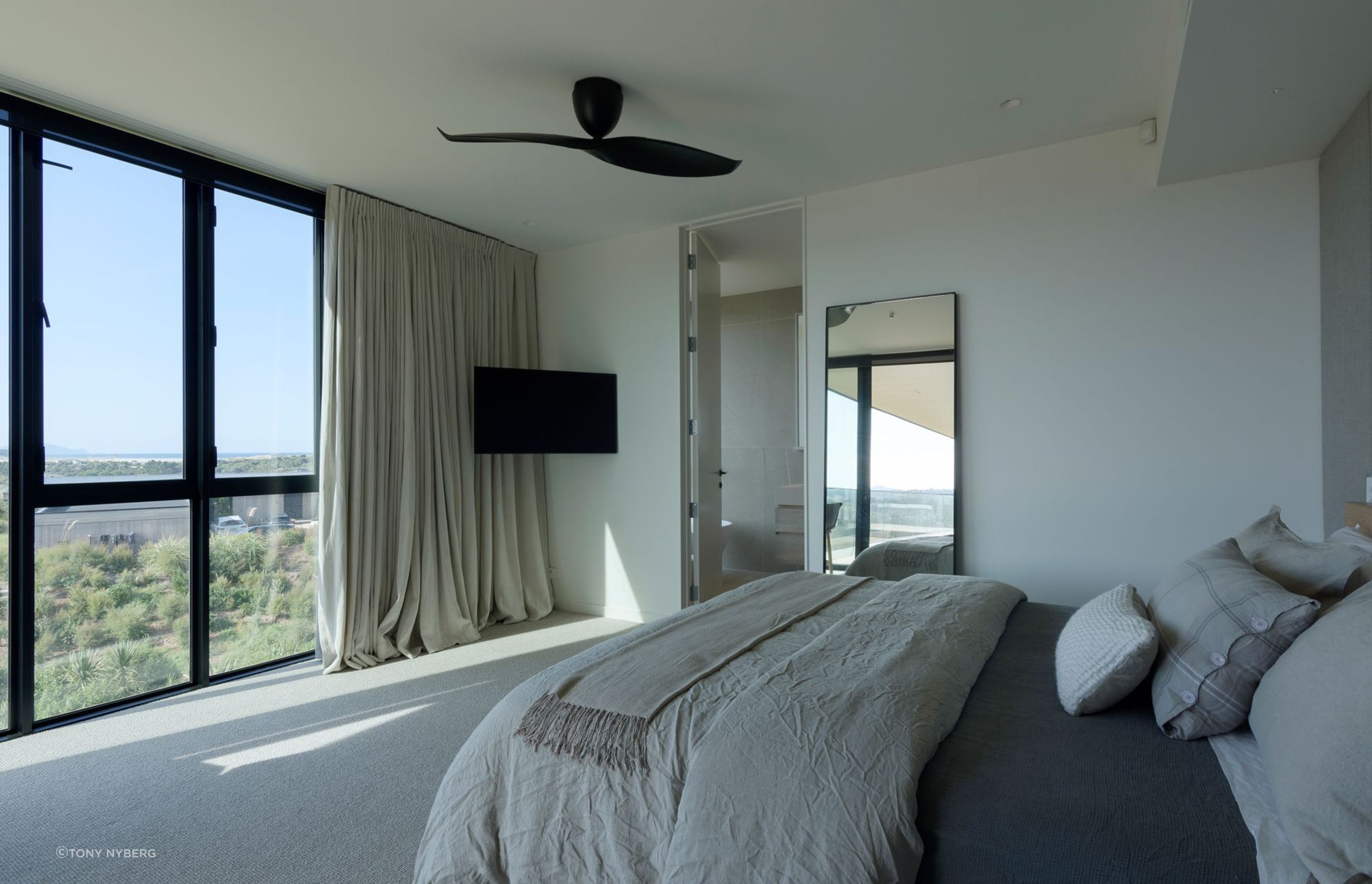 A relaxed aesthetic continues into the bedrooms – each enjoying views through floor-to-ceiling windows.