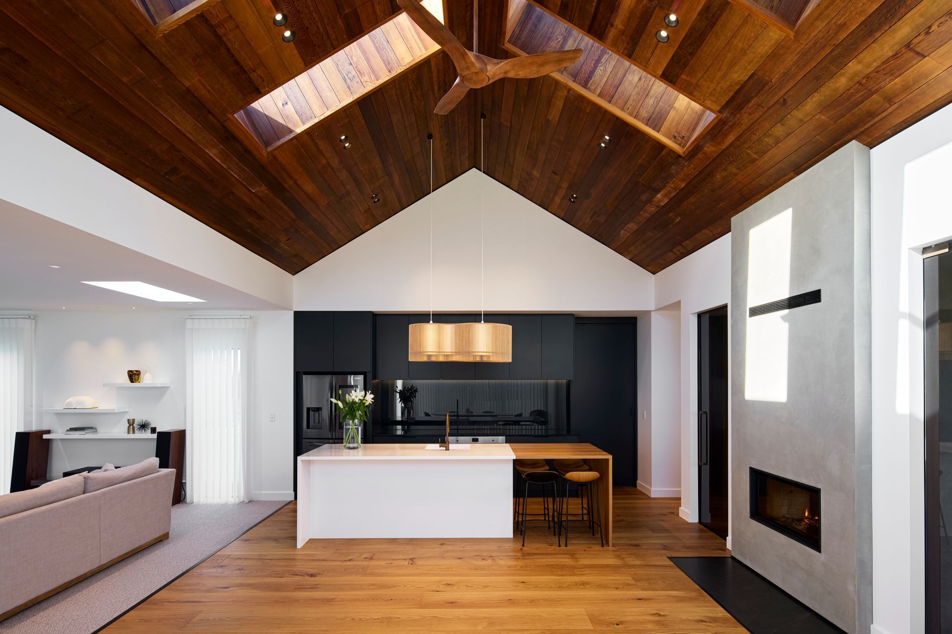 Cedar lines the ceiling, with hardwood American oak flooring a contrast to the sleek, dark kitchen cabinetry.
