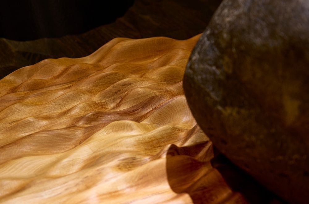 The undulating waves referencing the source river were carved into native rimu timber that sits beneath the mouri stone using a CNC machine.